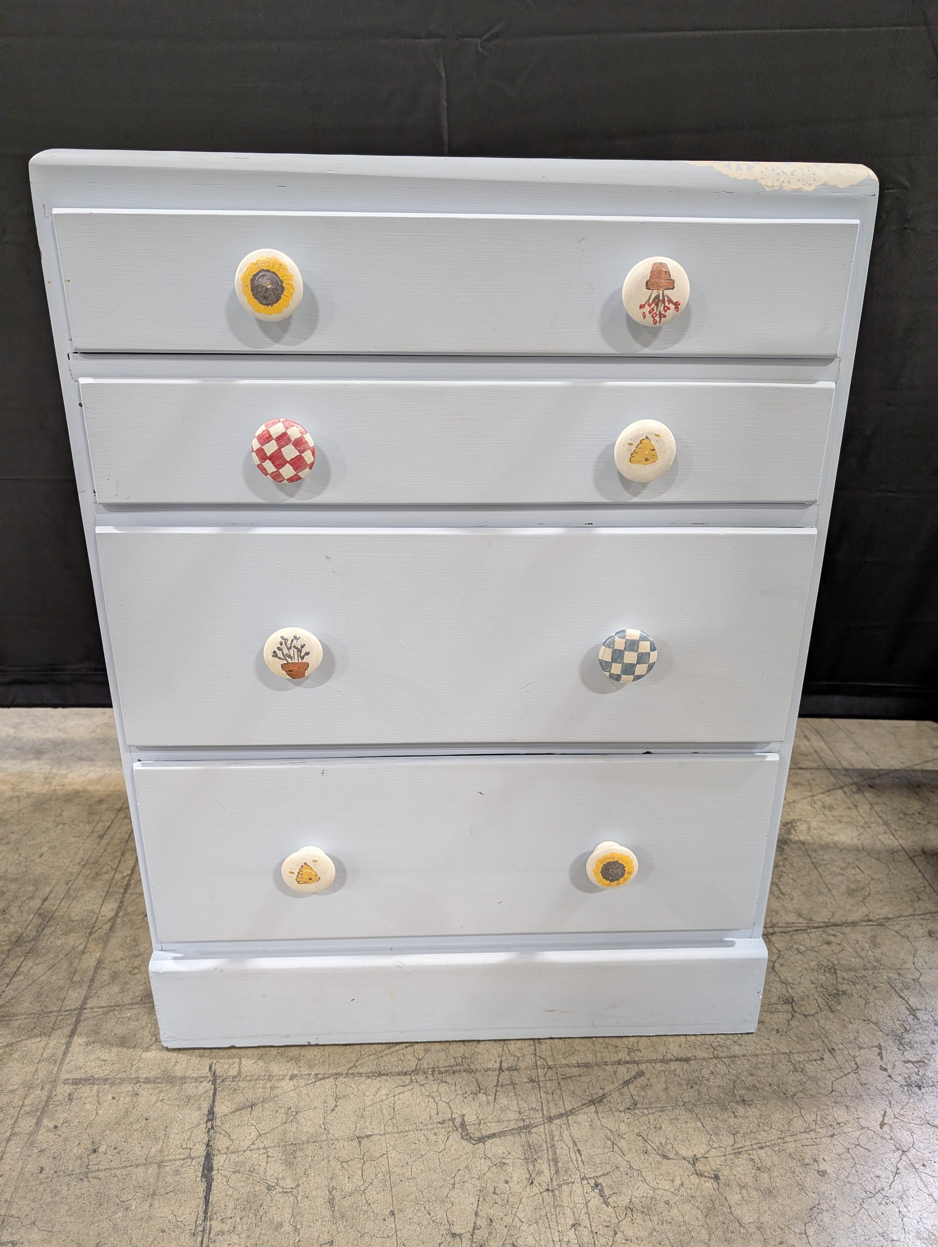 Pale Blue Wooden Four-Drawer Chest with Decorative Knobs