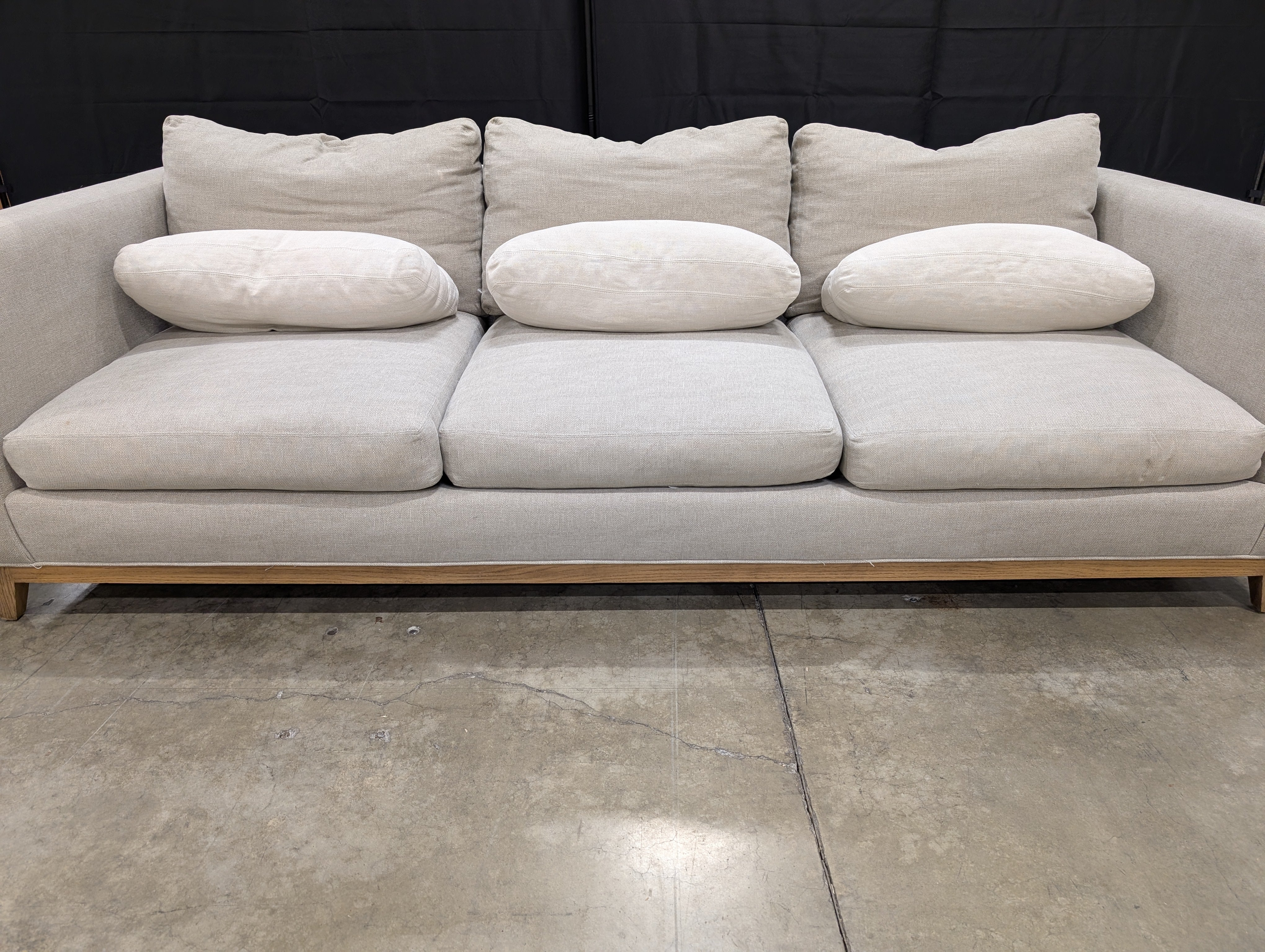 Crate & Barrel Oatmeal Fabric Sofa with Wood Base and Bolster Pillows