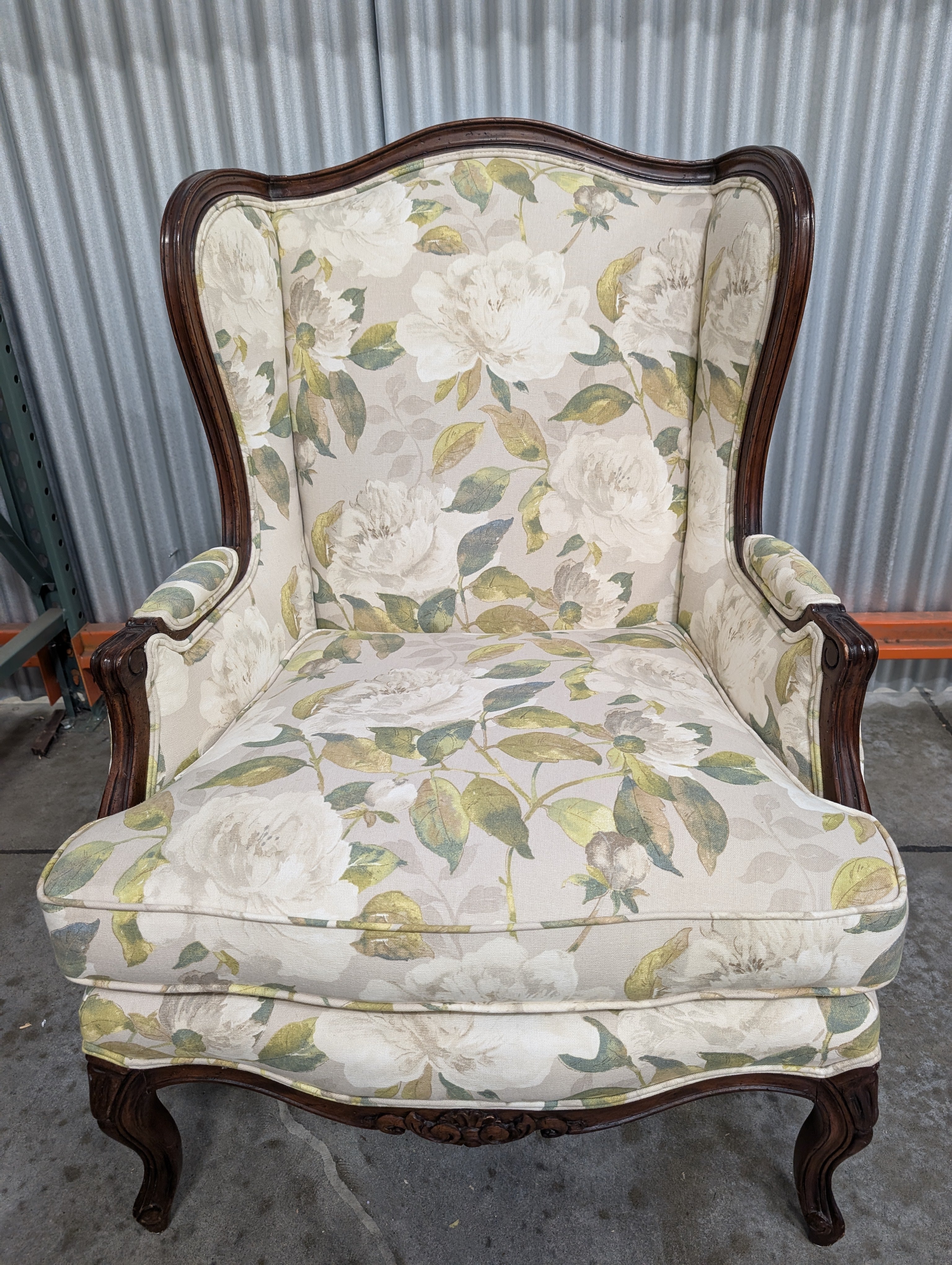 Vintage Wingback Armchair with Floral Upholstery and Carved Wood Frame