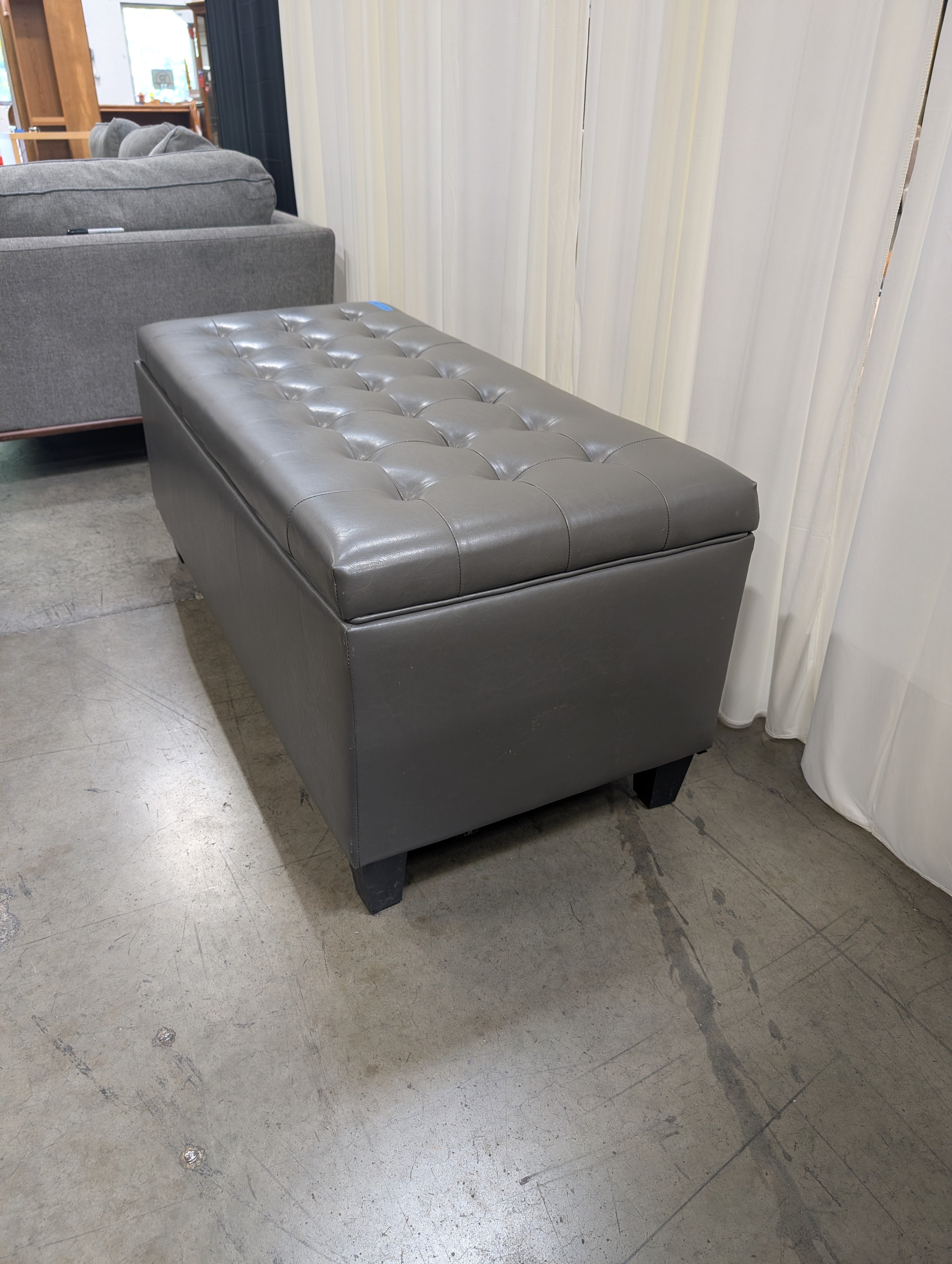 Charcoal Tufted Storage Ottoman in Faux Leather