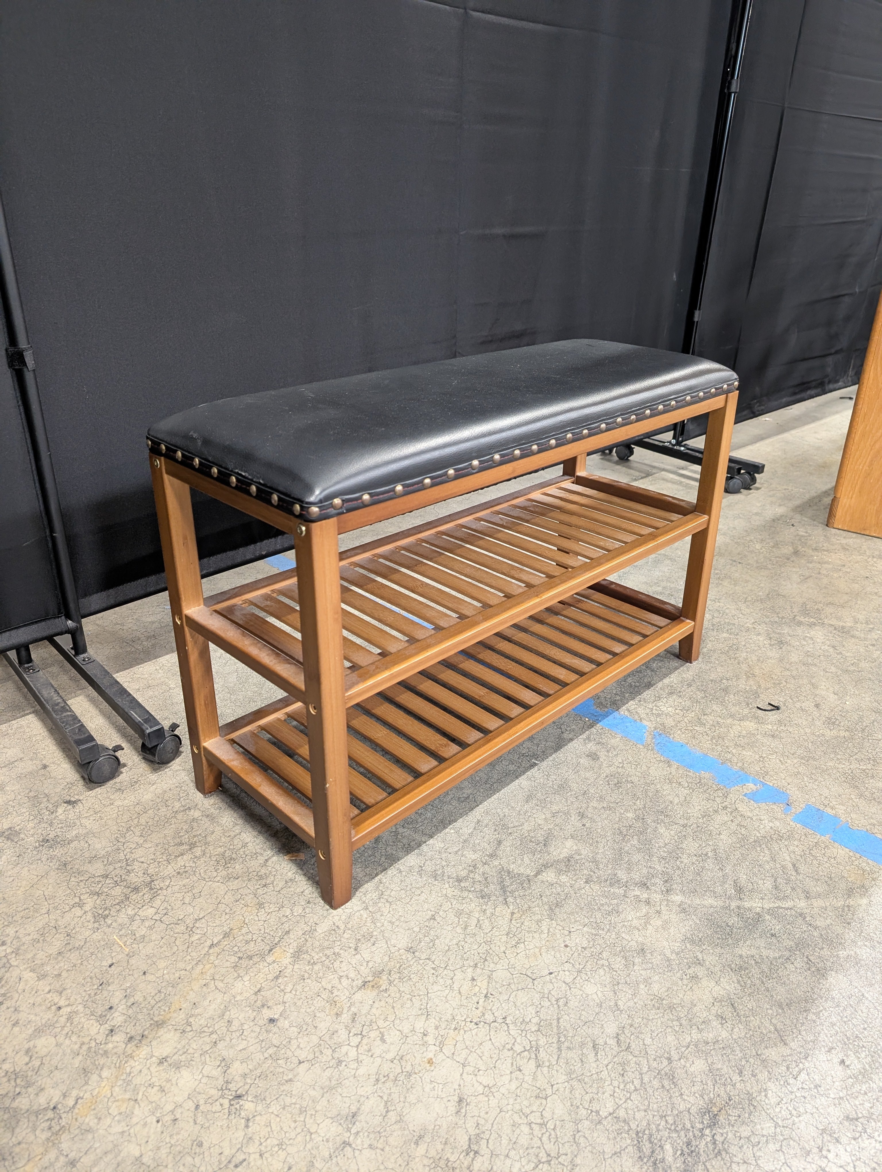 Hardwood Entryway Bench with Padded Black Upholstery and Slatted Shelves
