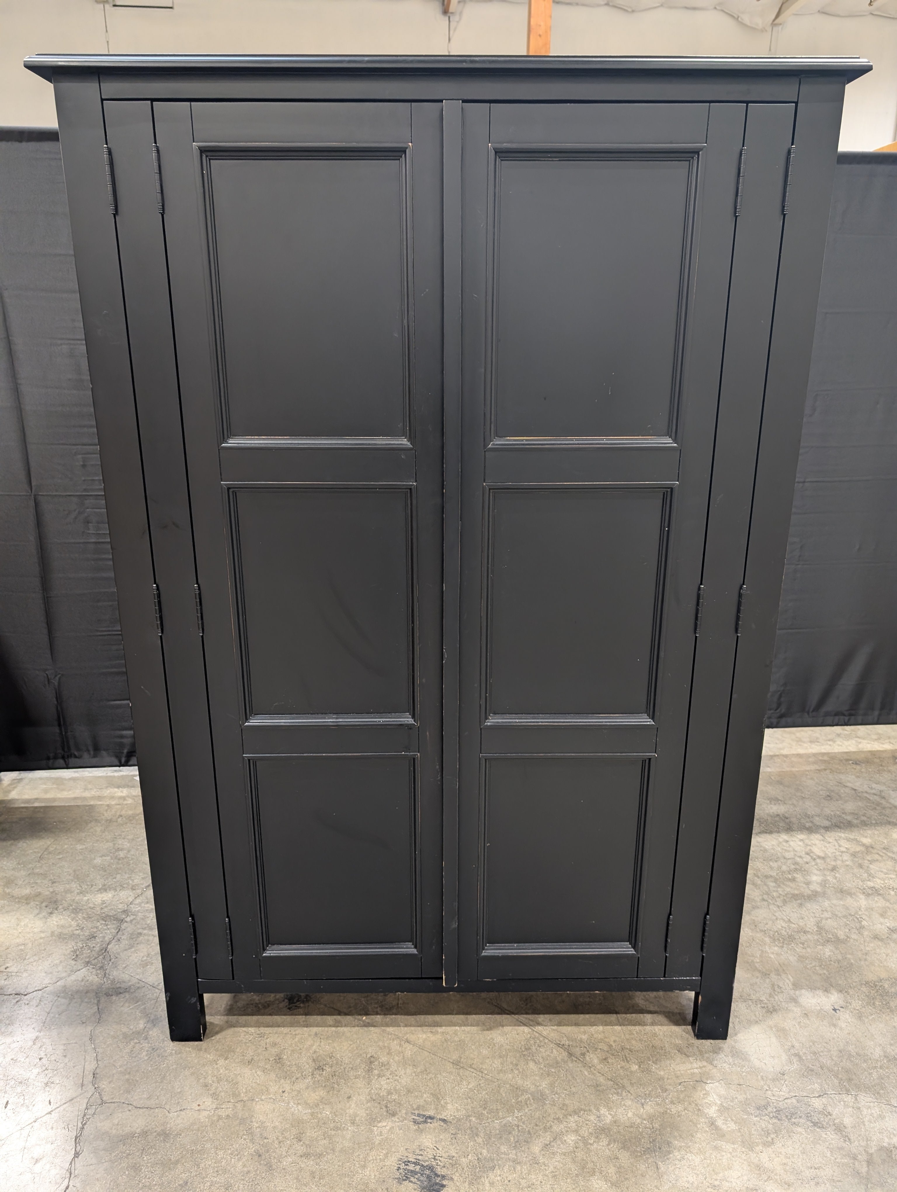 Versatile Black Wood Storage Armoire with Paneled Doors