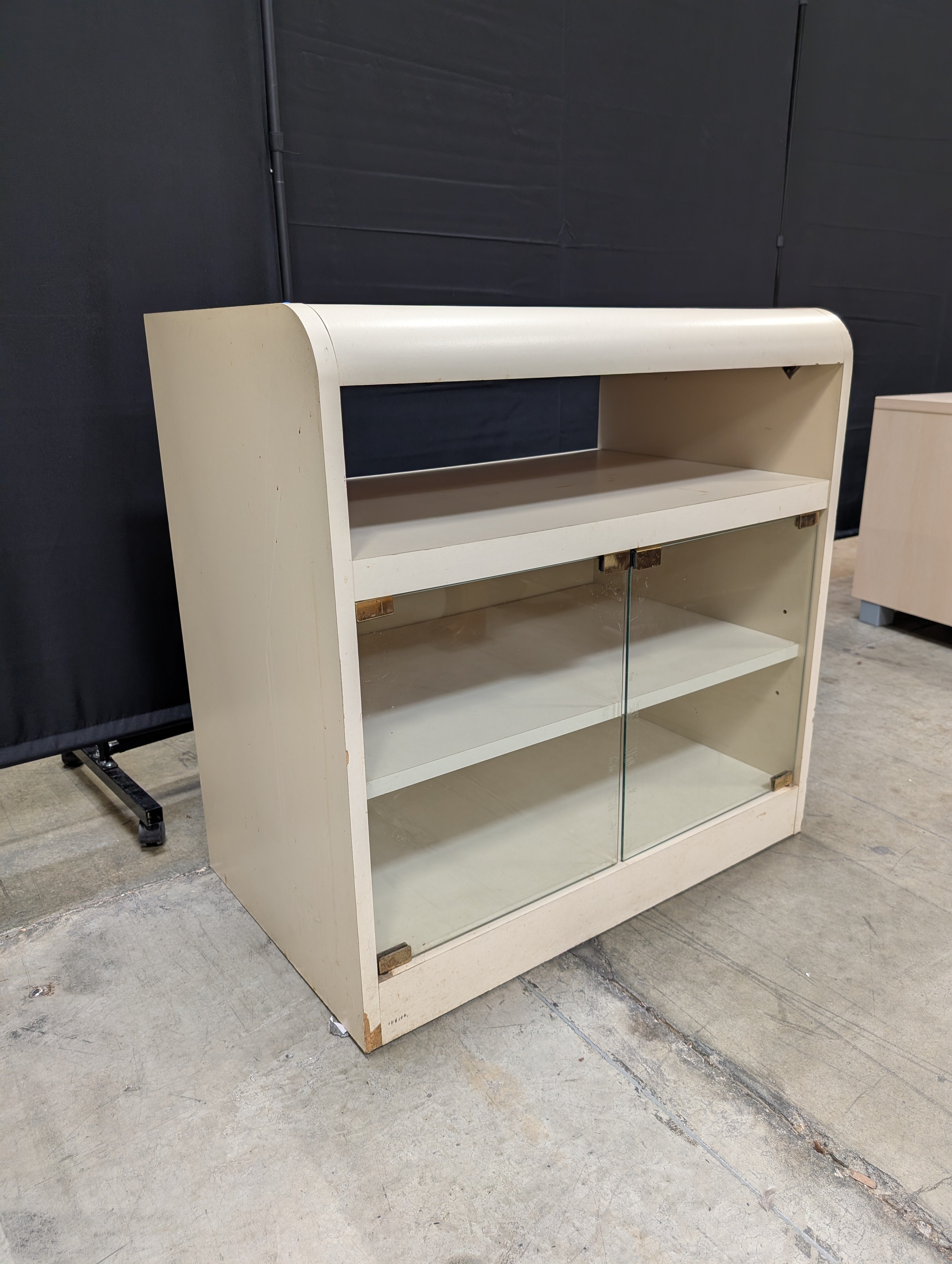 Compact Cream Storage Cabinet with Glass Doors and Curved Design