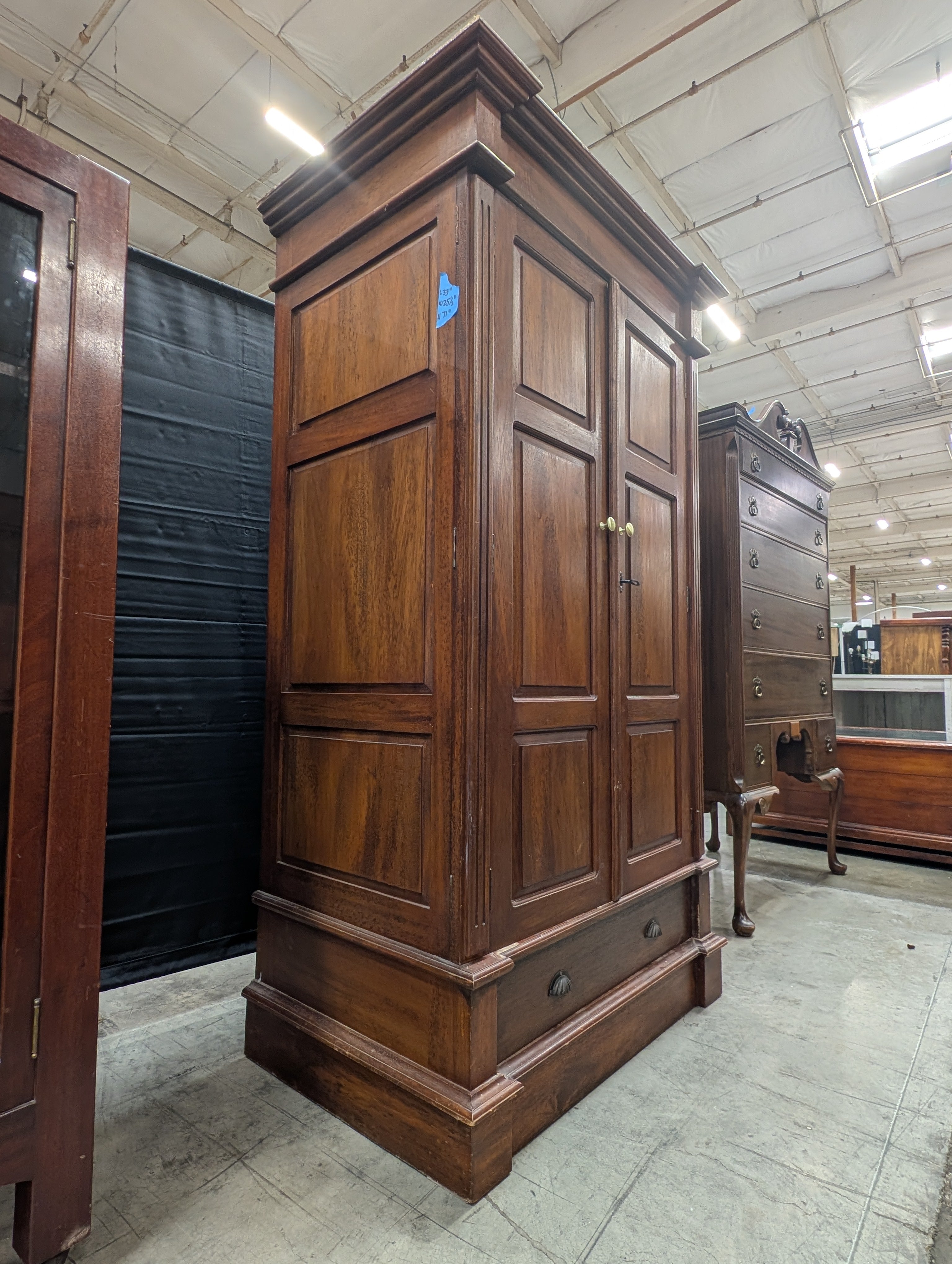 Stately Dark Wood Paneled Armoire with Drawer