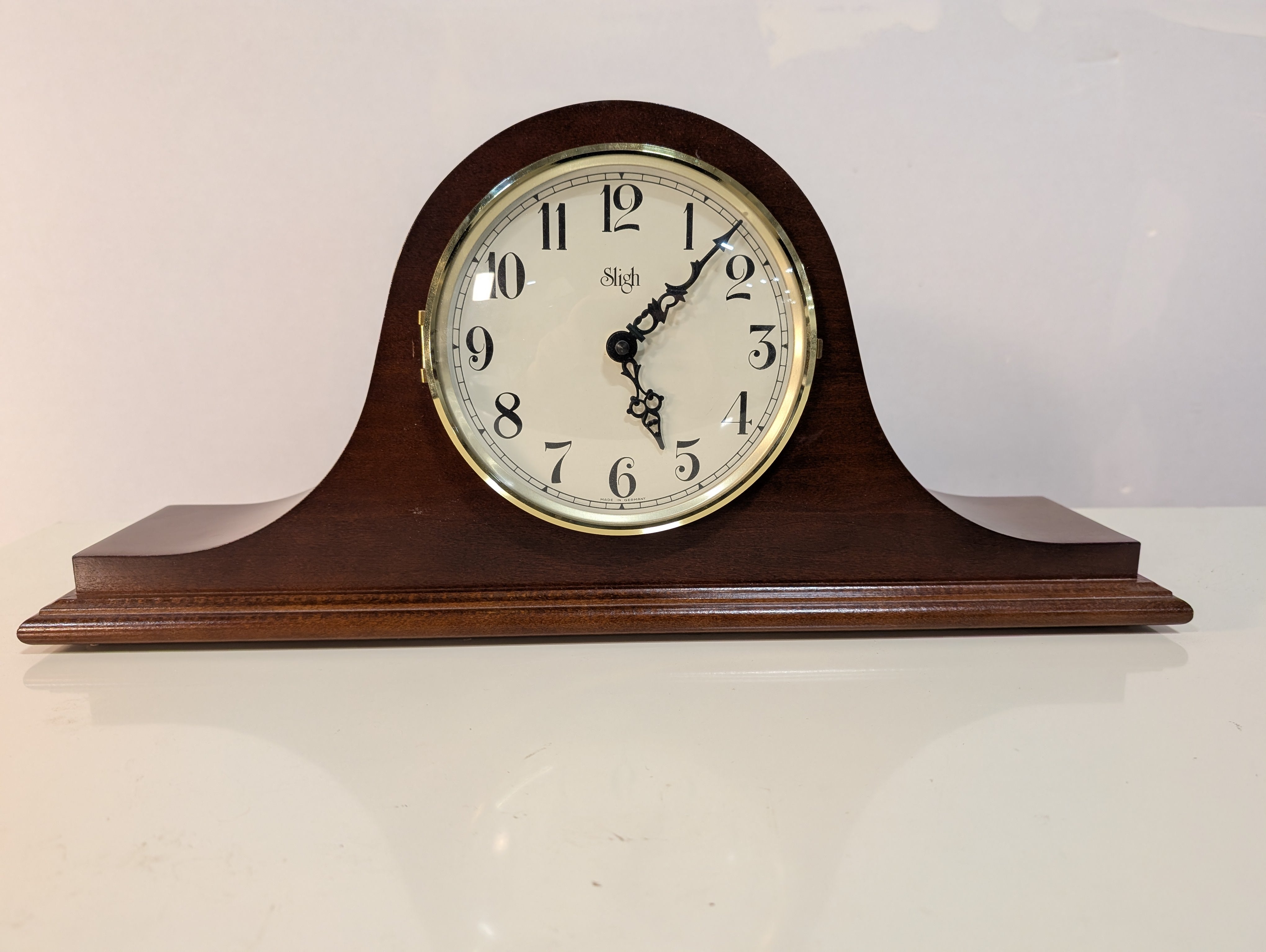 Curved Dark Wood Table Clock with Brass Tone Bezel