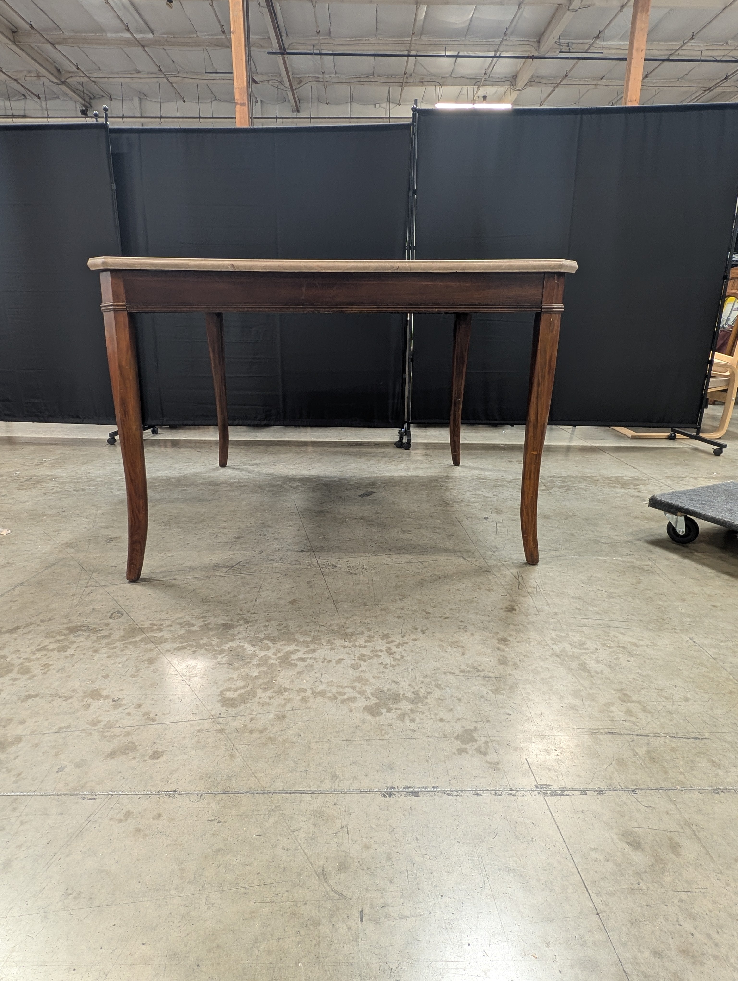 Stone Top Dining Table with Tapered Wood Legs has chip
