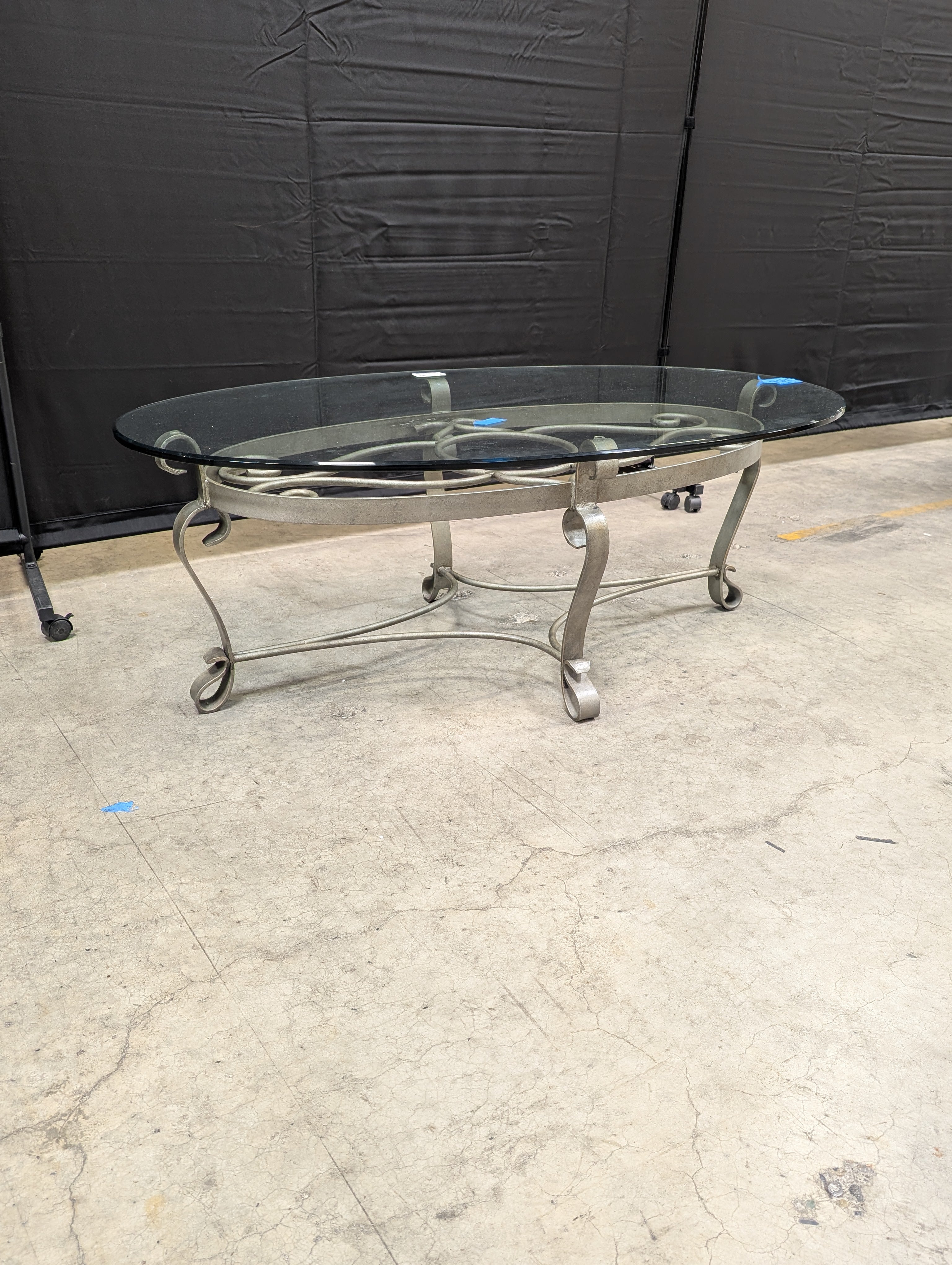 Oval Glass Top Coffee Table with Ornate Scrolled Metal Base