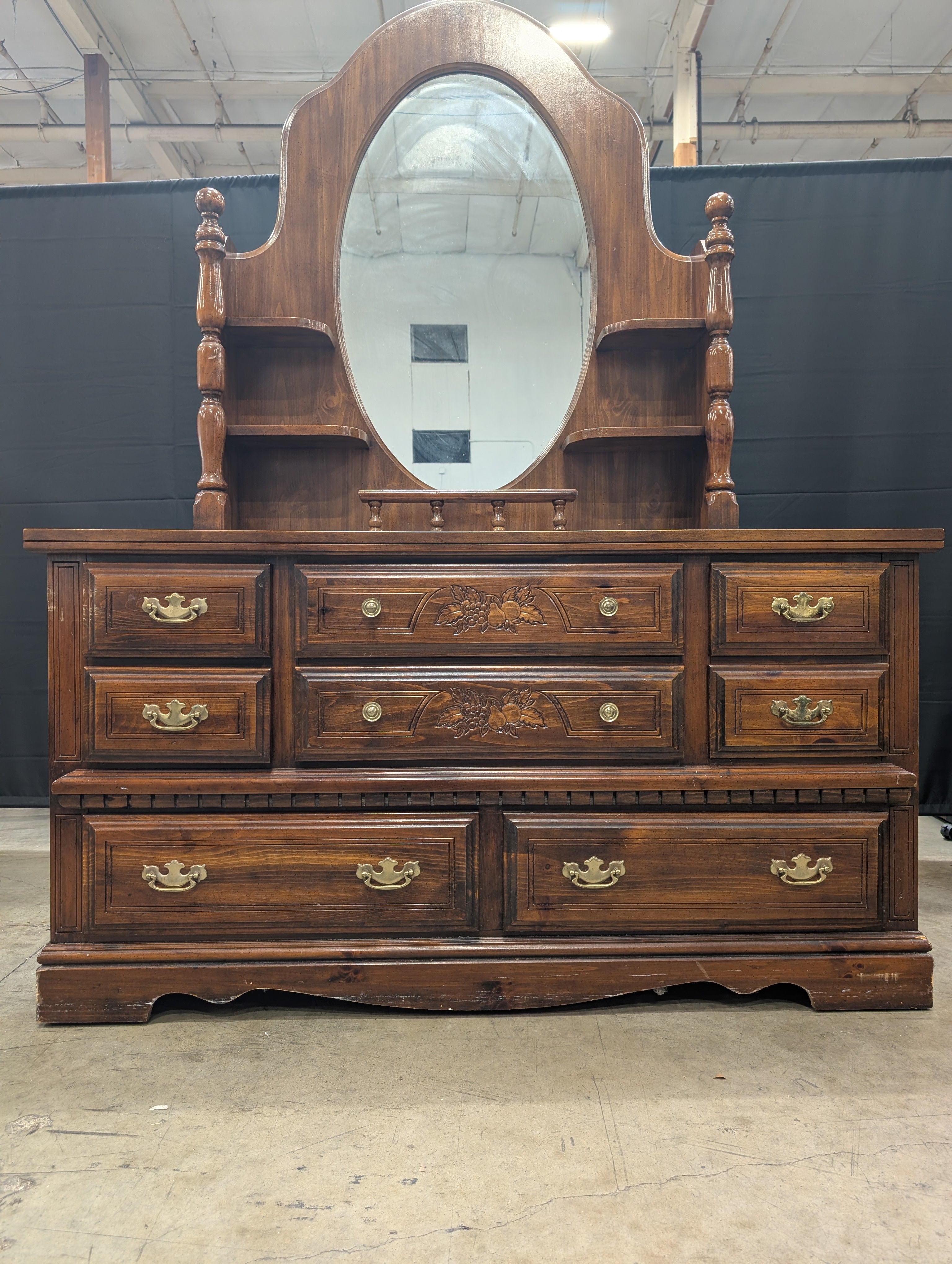 Traditional Dark Wood Dresser with Oval Mirror and Carved Accents