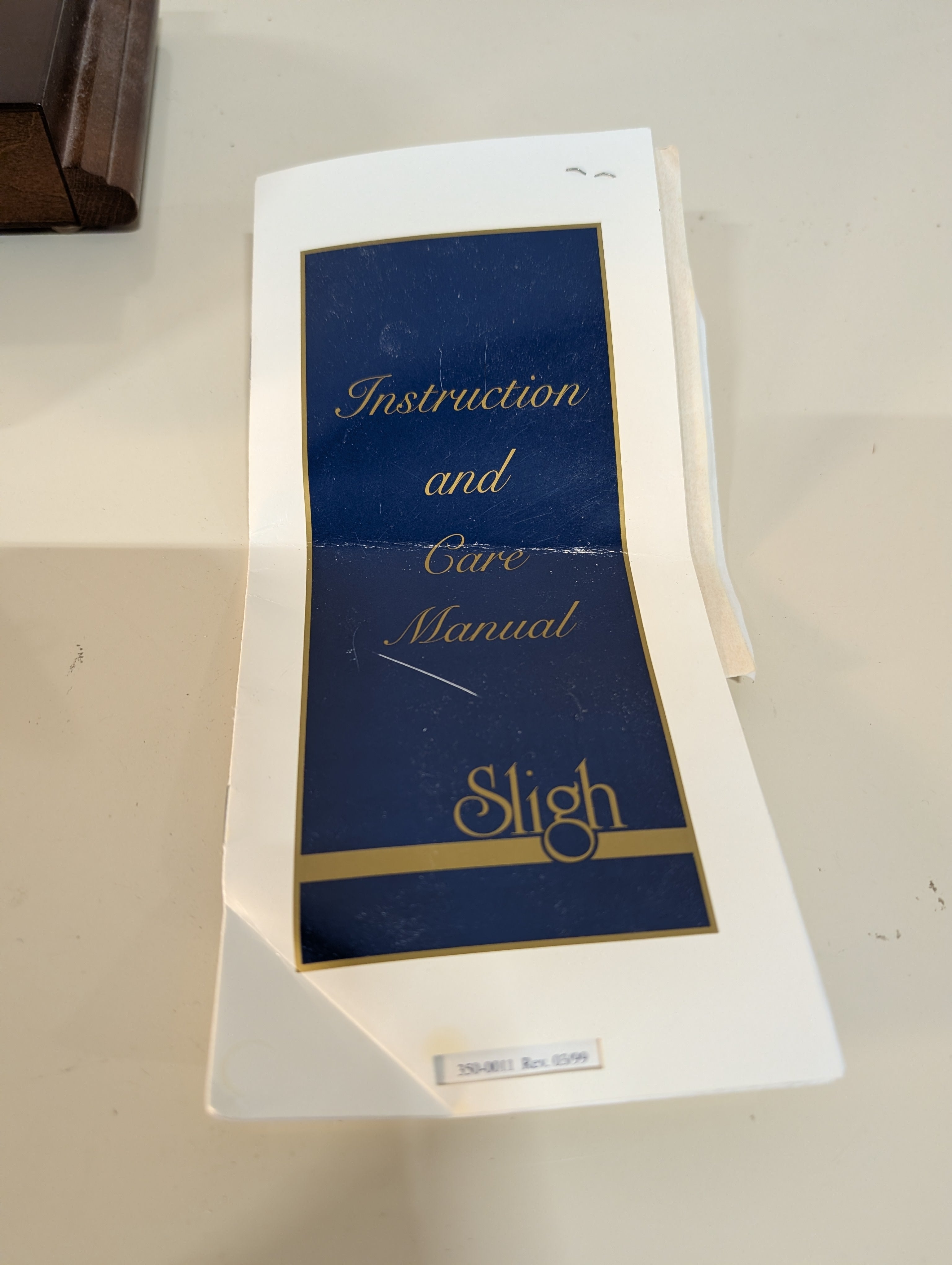 Curved Dark Wood Table Clock with Brass Tone Bezel