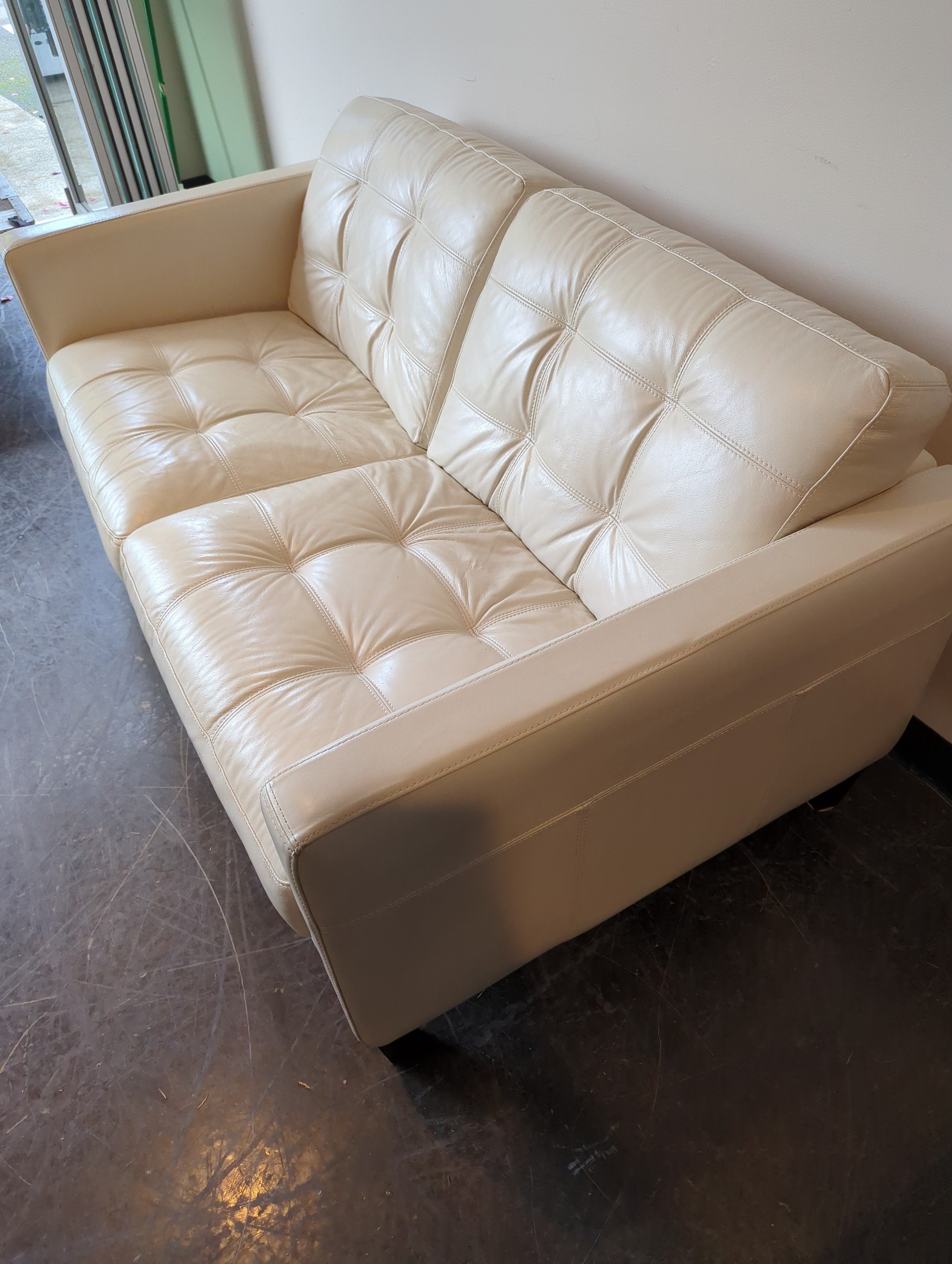 Chateau d'Ax Cream Leather Two-Seater Sofa with Tufted Cushions