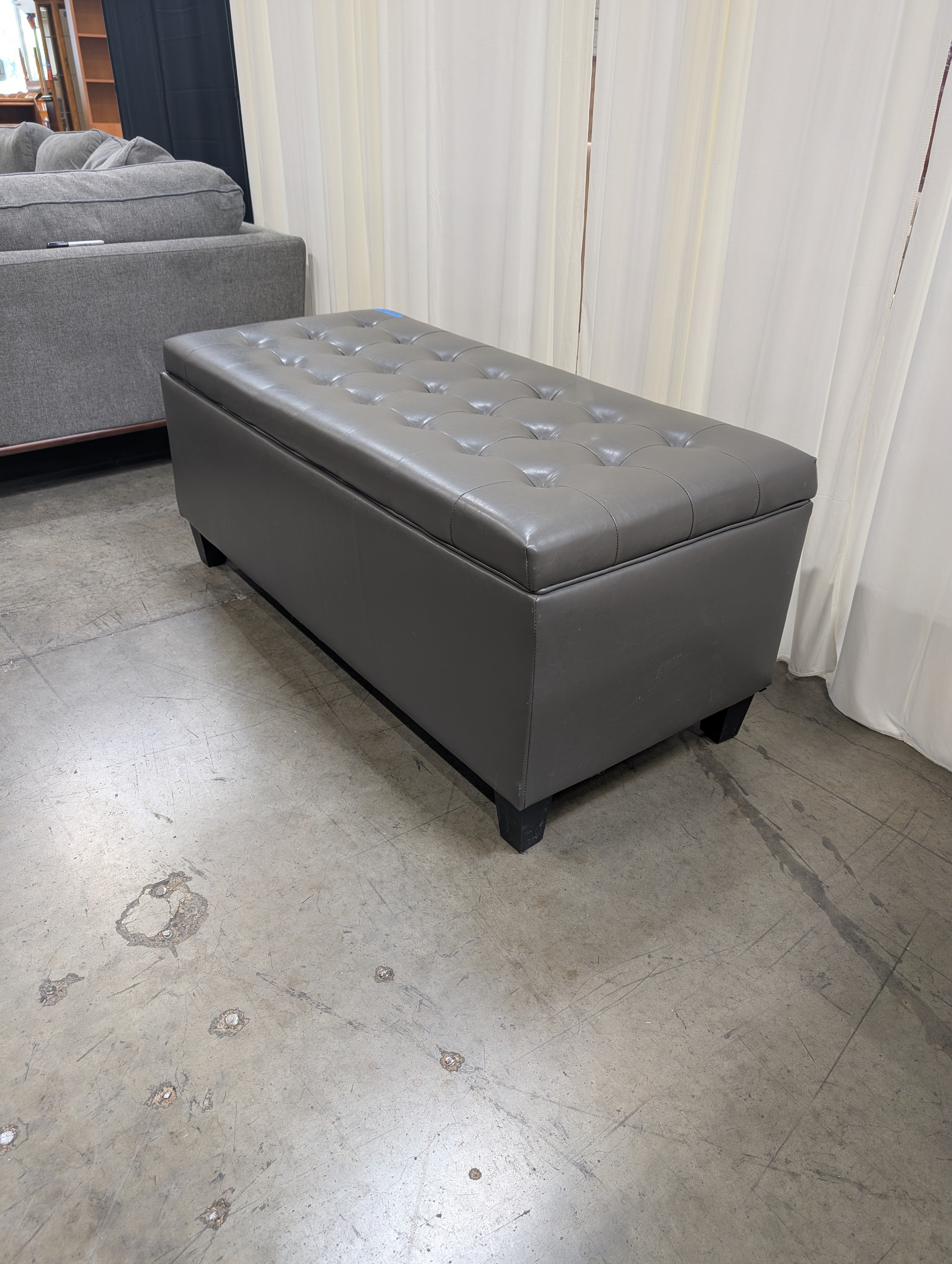 Charcoal Tufted Storage Ottoman in Faux Leather