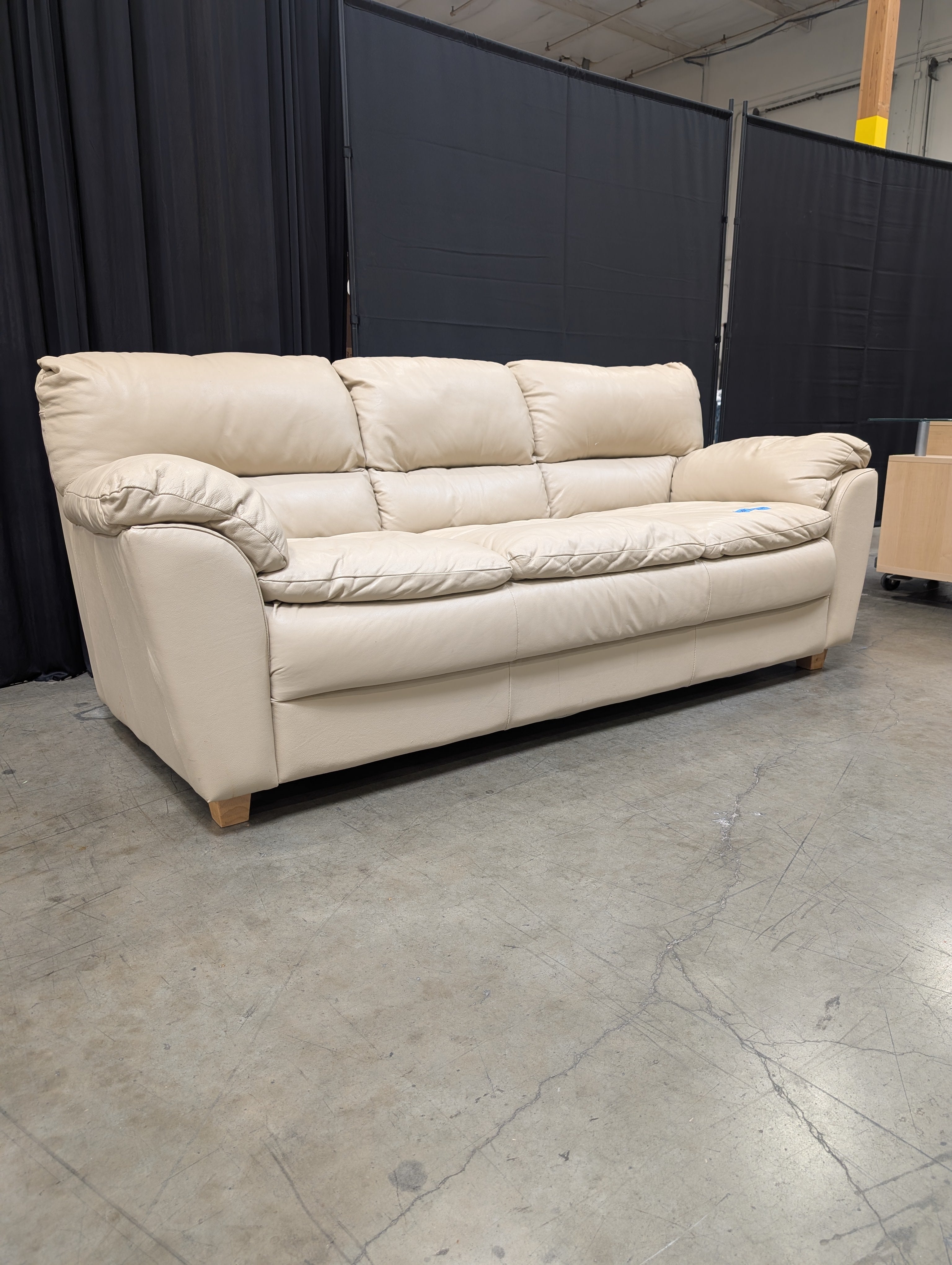 Cream Three-Seat Leather Couch with Pillow Arms