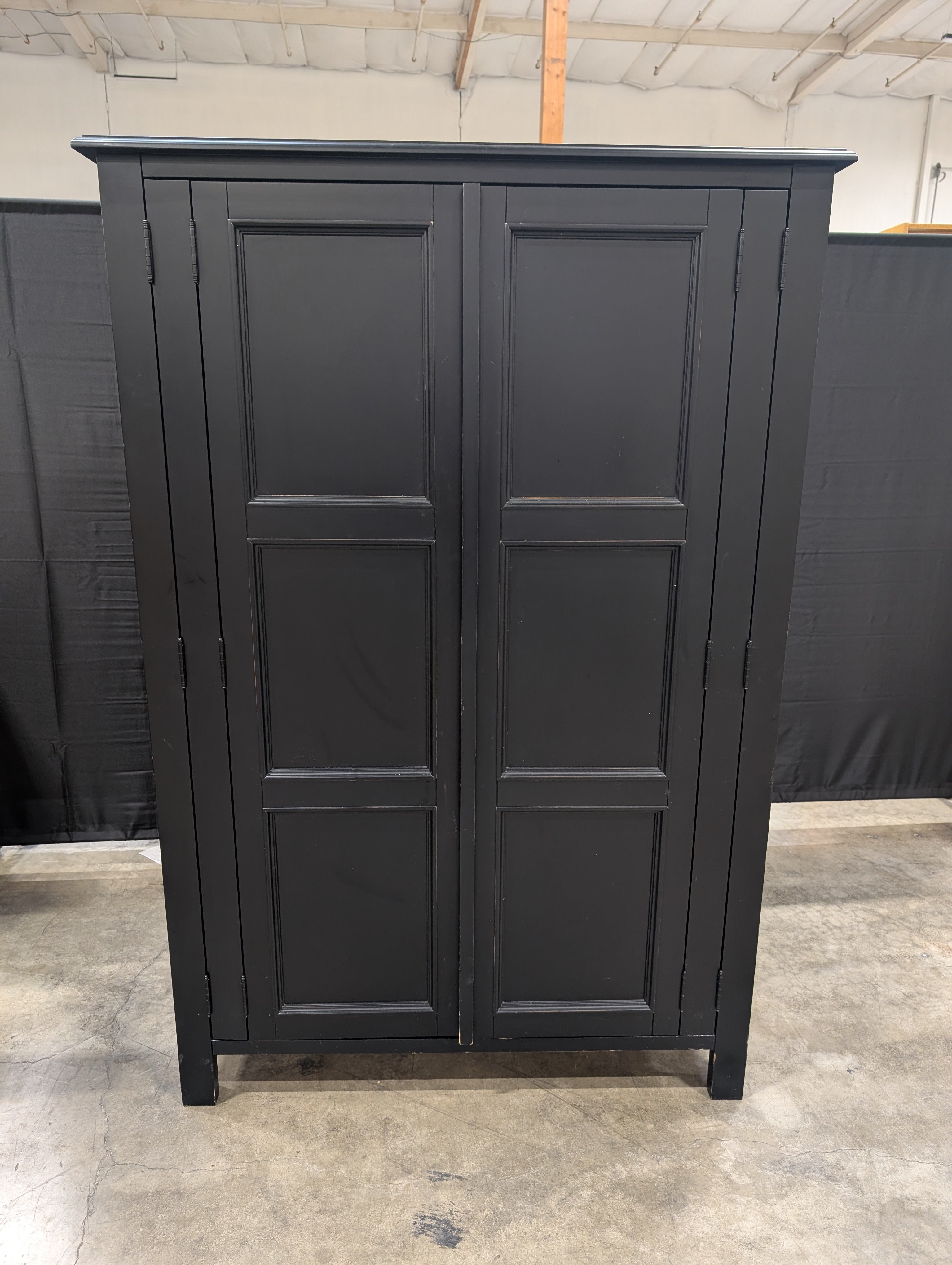 Versatile Black Wood Storage Armoire with Paneled Doors