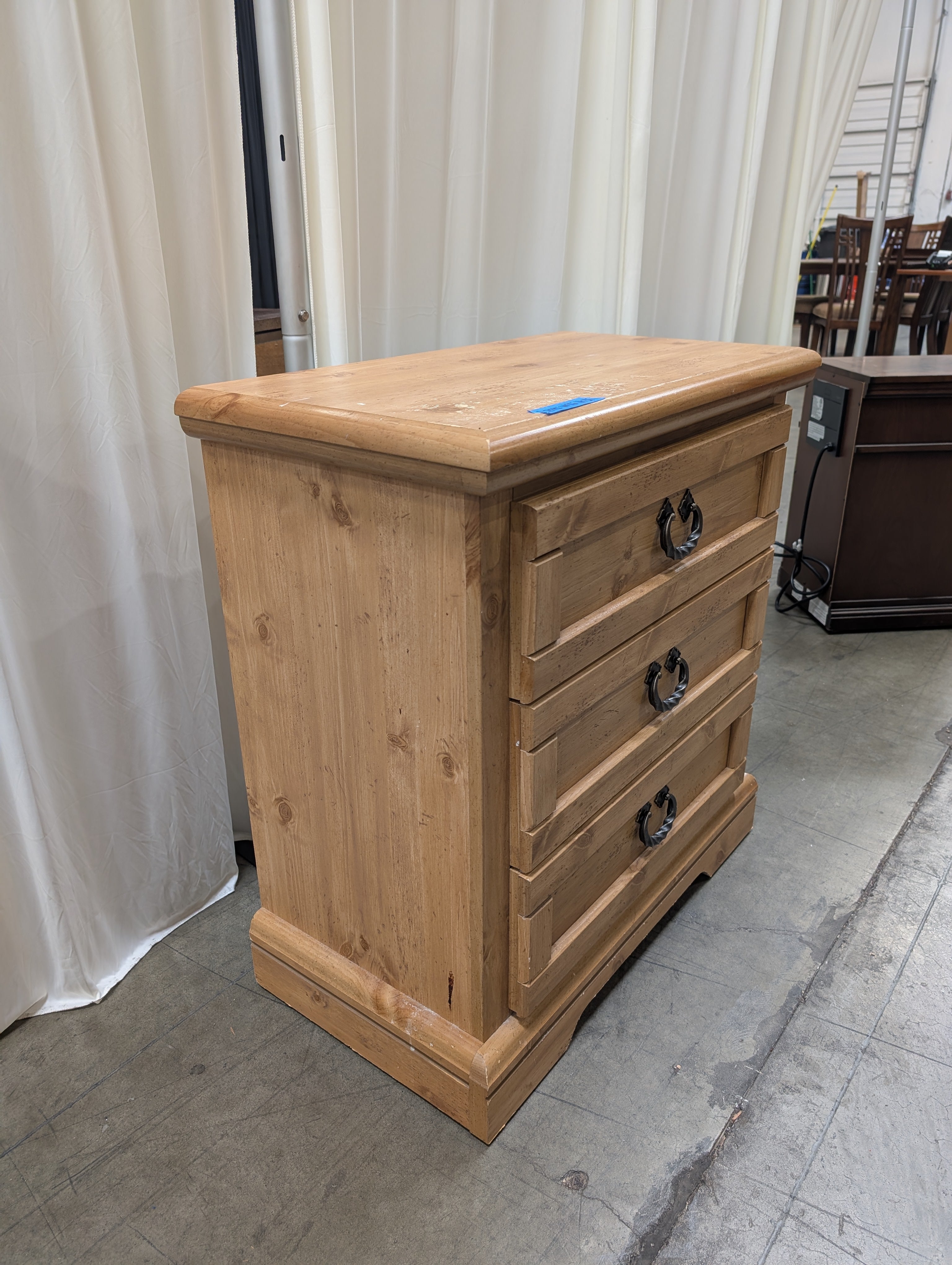 Light Wood Three-Drawer Nightstand with Metal Pulls