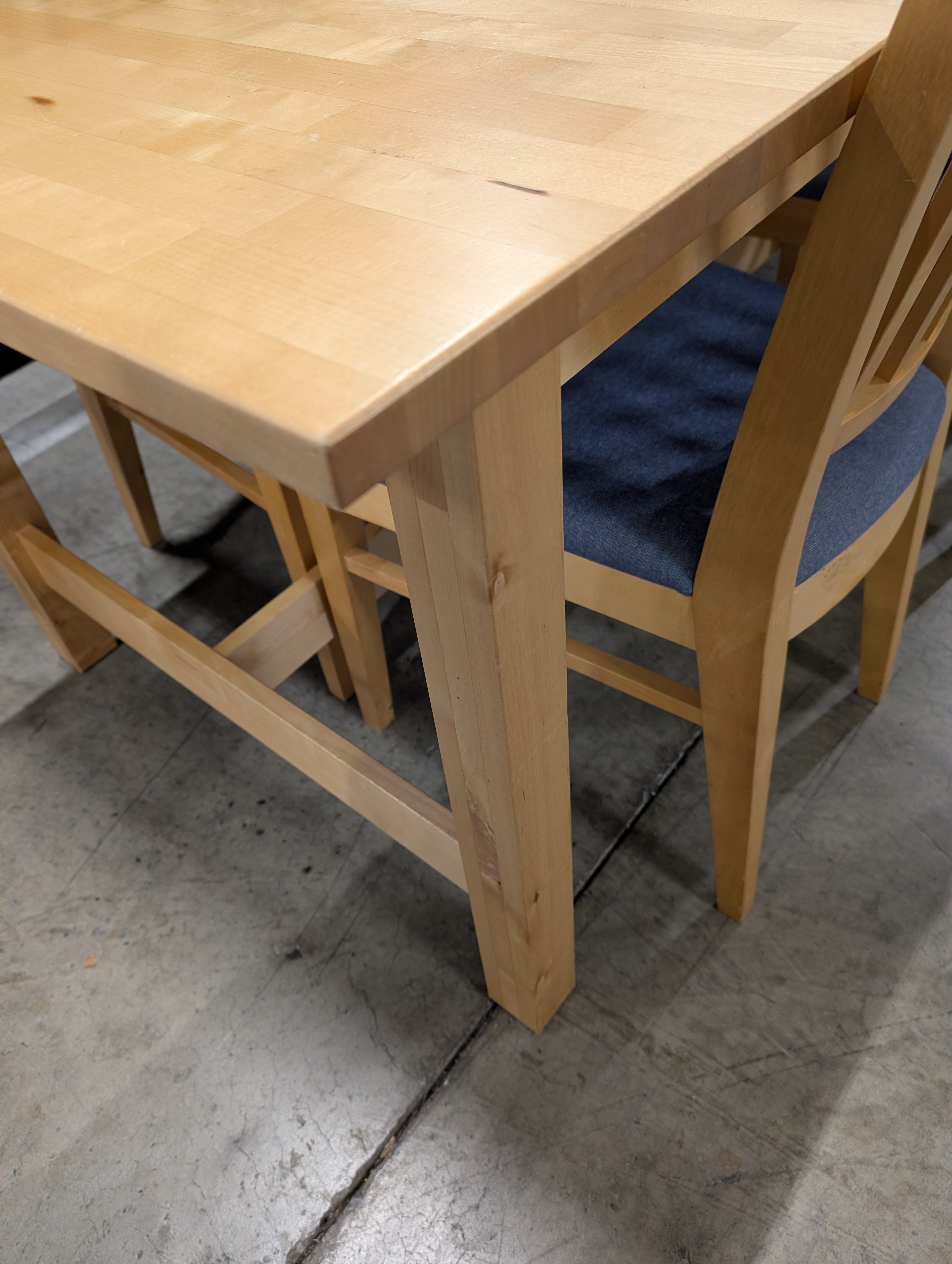 Versatile Extendable Light Wood Dining Table with Six Blue Upholstered Chairs