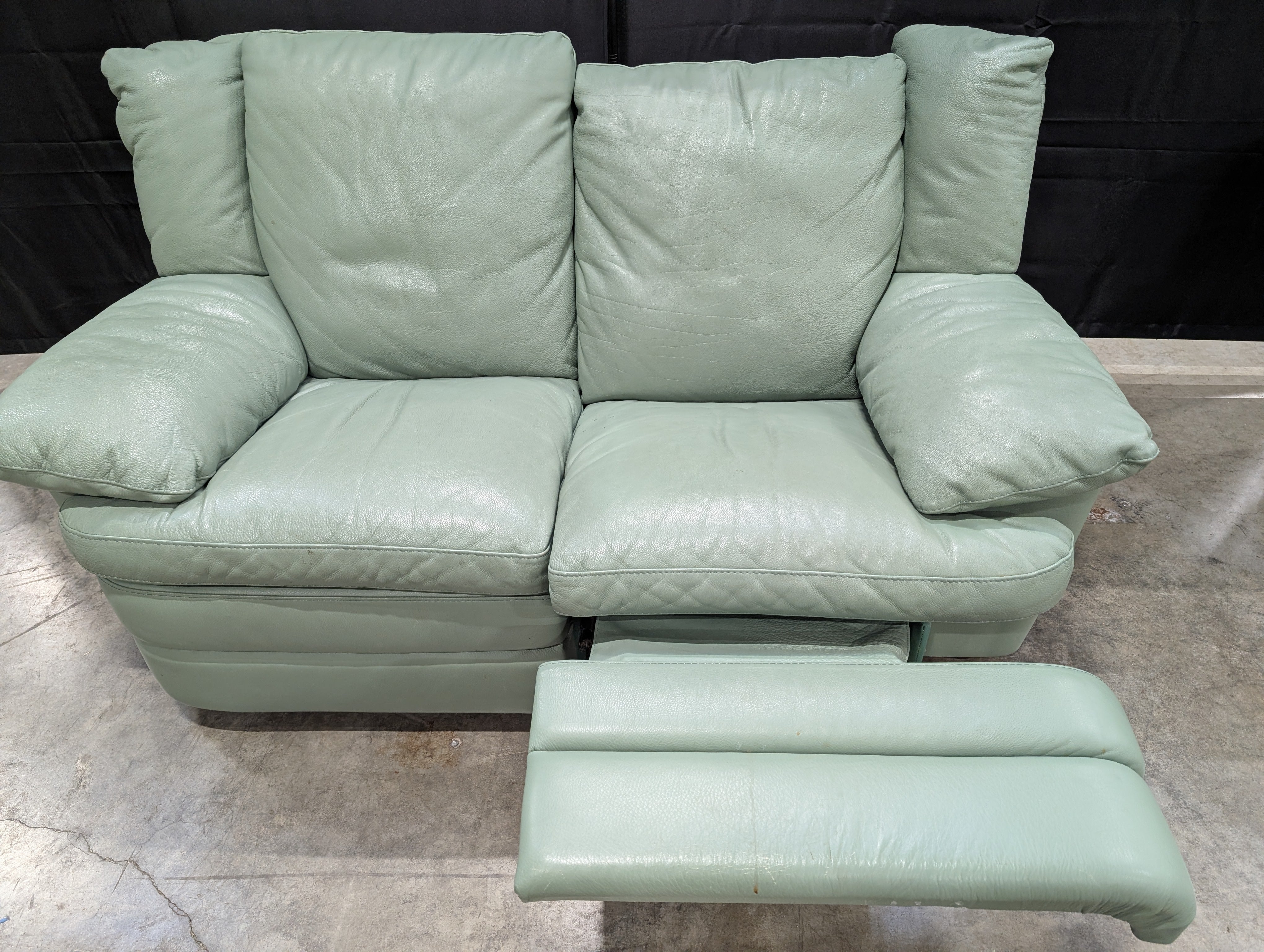 Charming Mint Green Leather Two-Seater Sofa with Plush Padded Arms