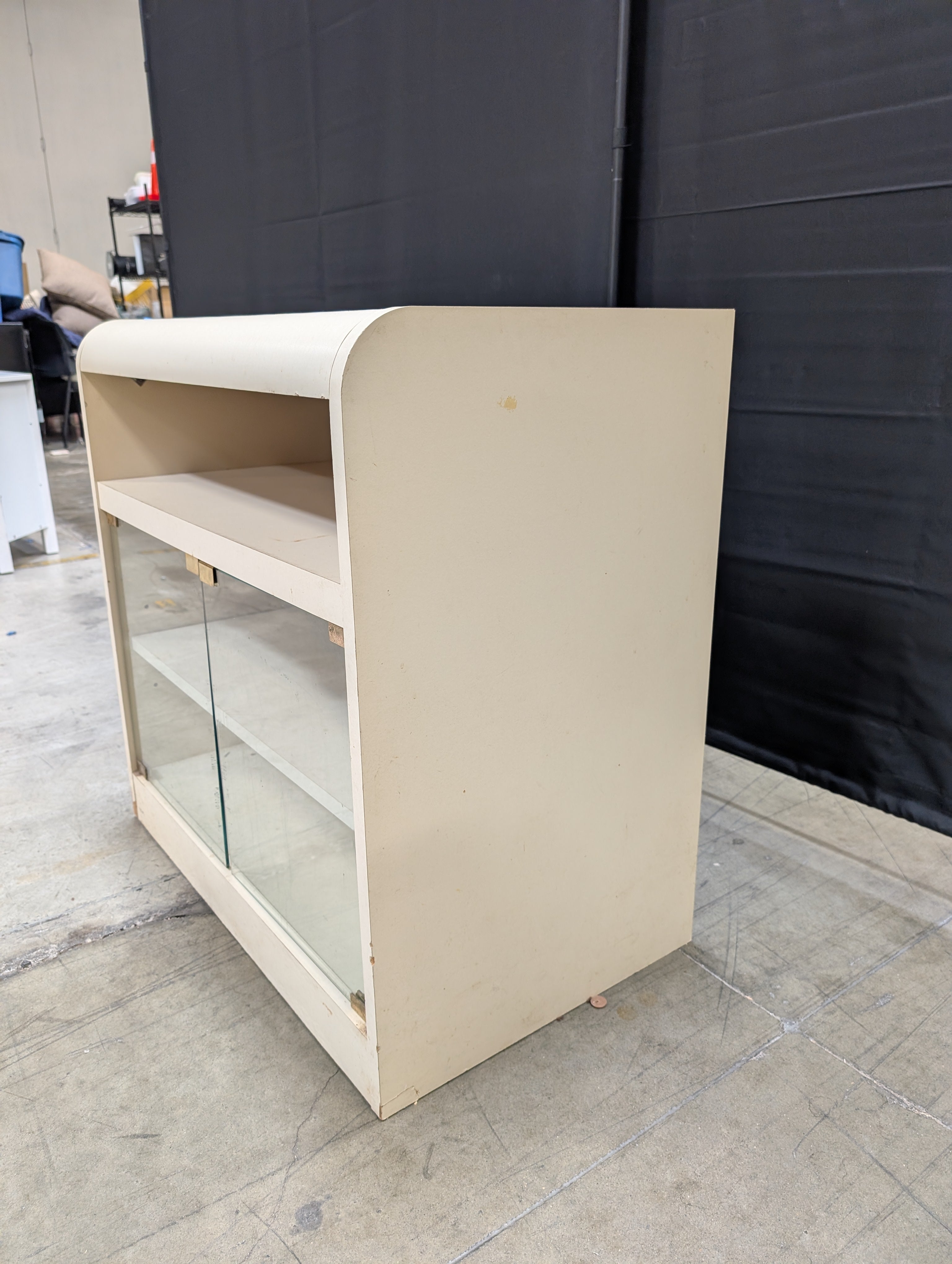 Compact Cream Storage Cabinet with Glass Doors and Curved Design