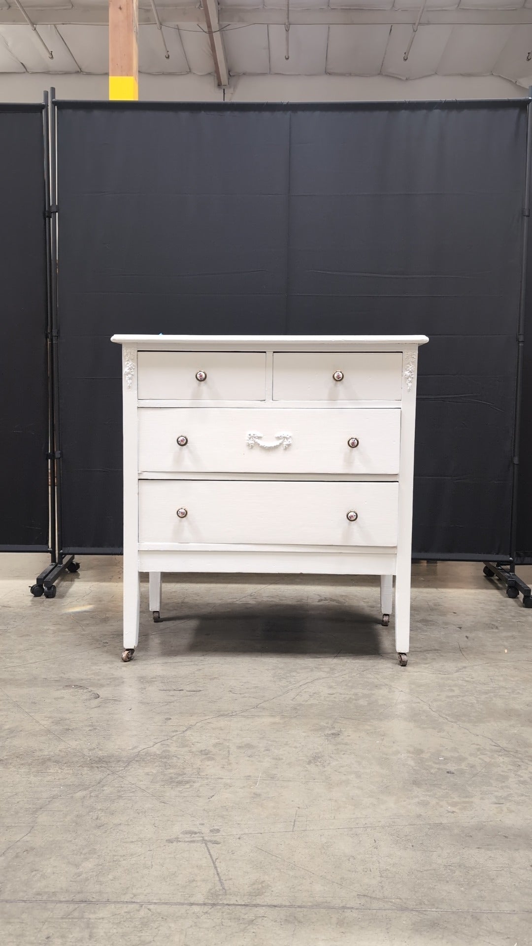 Charming White Four-Drawer Chest with Decorative Knobs