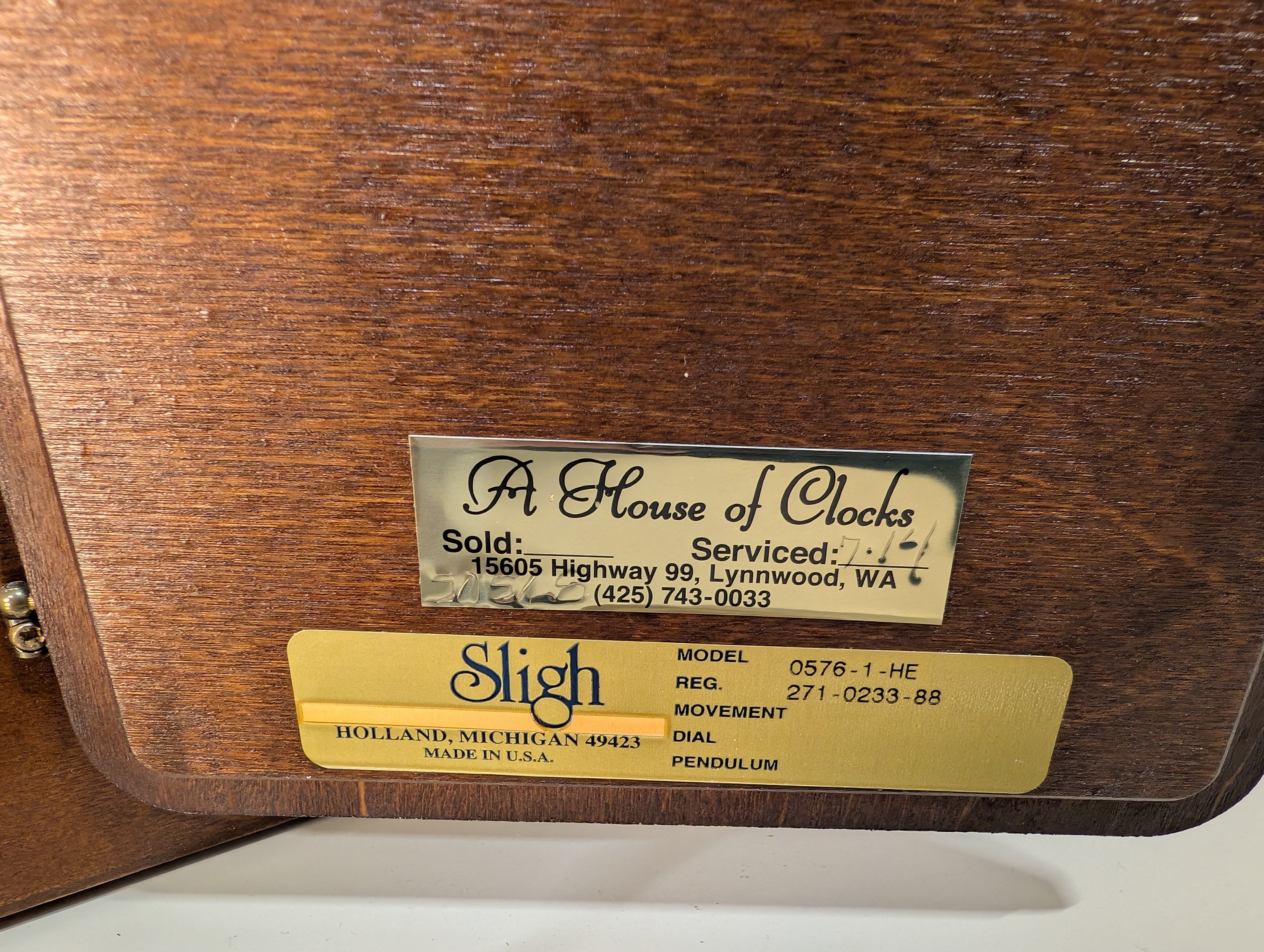 Curved Dark Wood Table Clock with Brass Tone Bezel