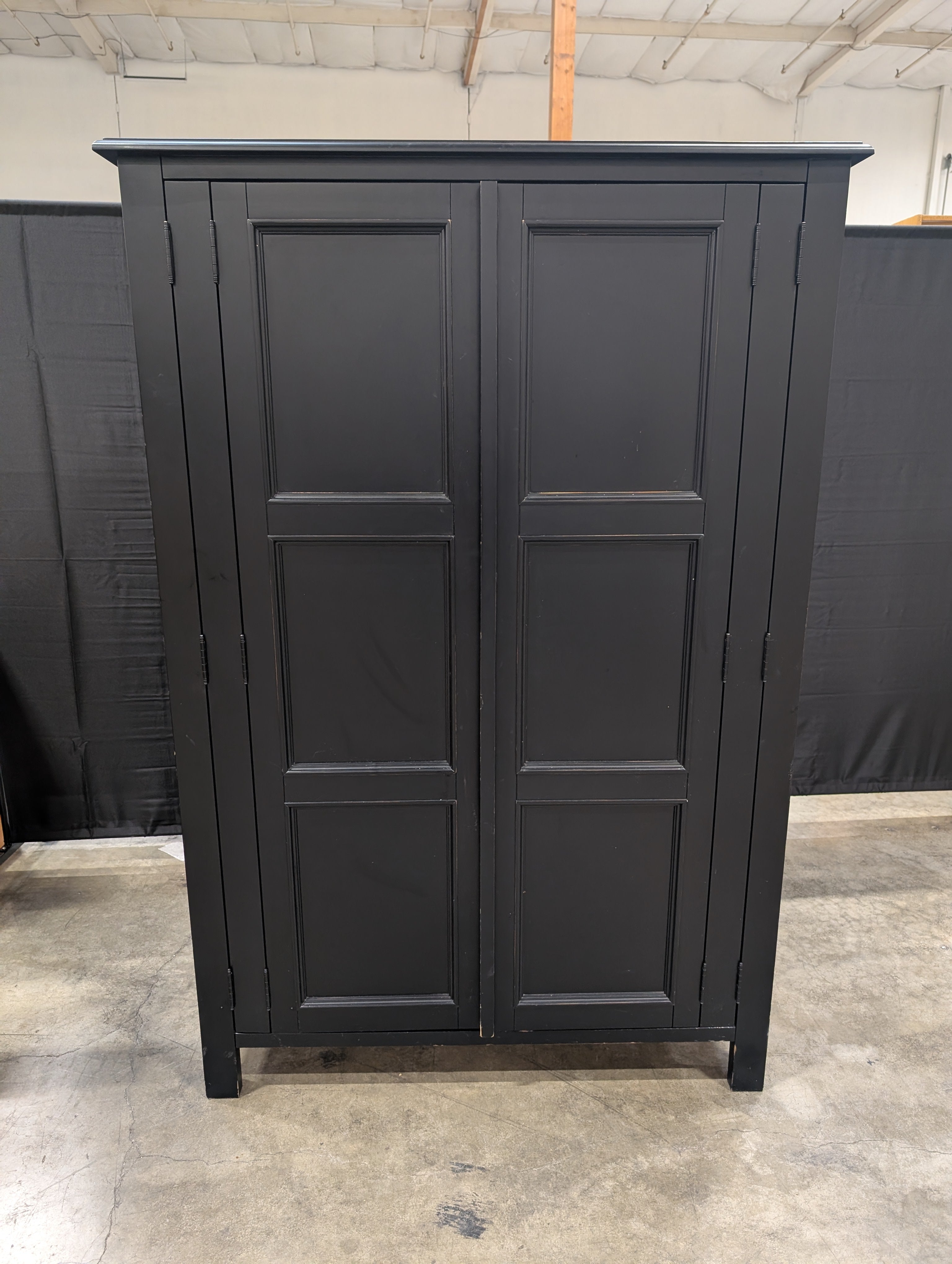 Versatile Black Wood Storage Armoire with Paneled Doors