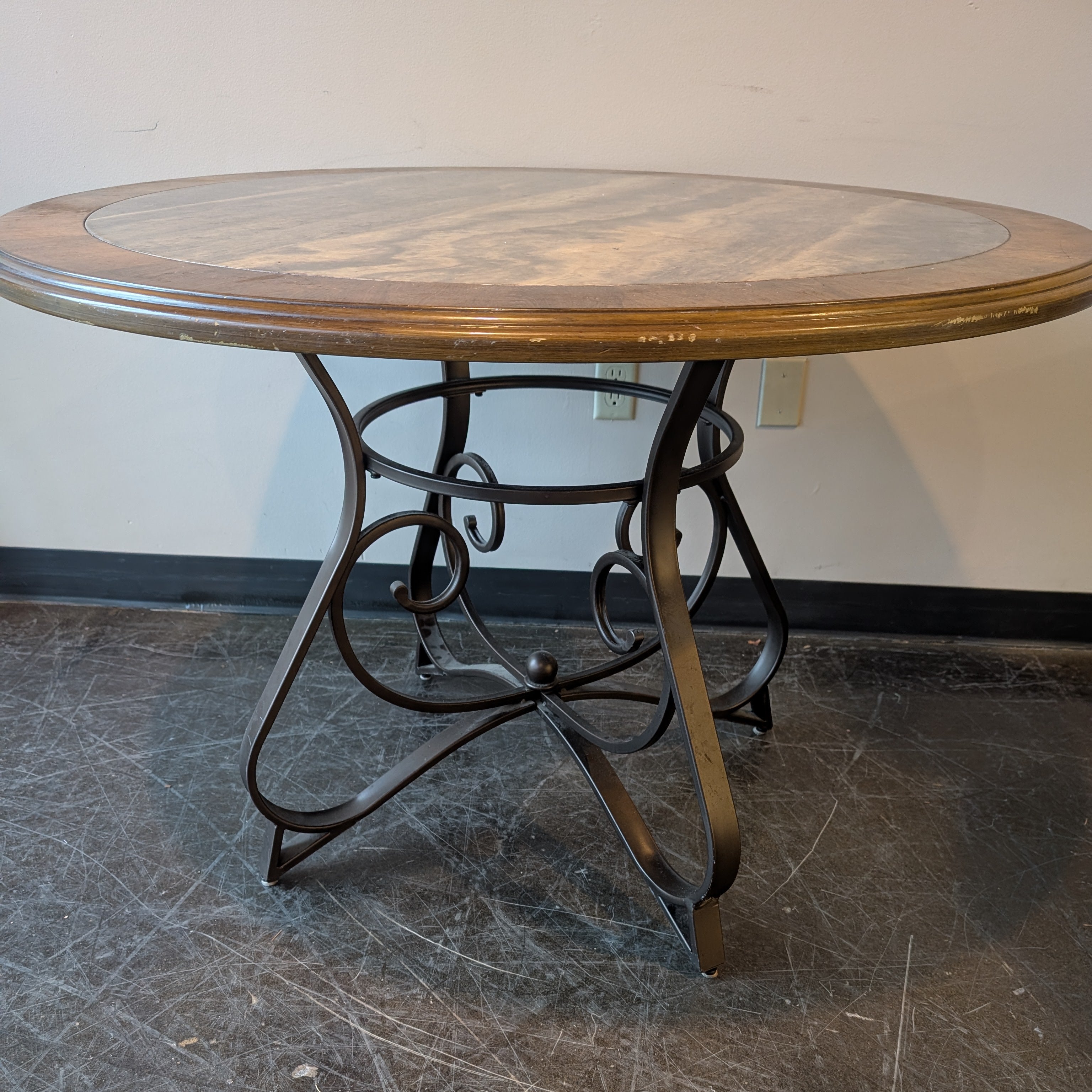 Round Stone Top Dining Table with Wood Trim and Metal Pedestal Base