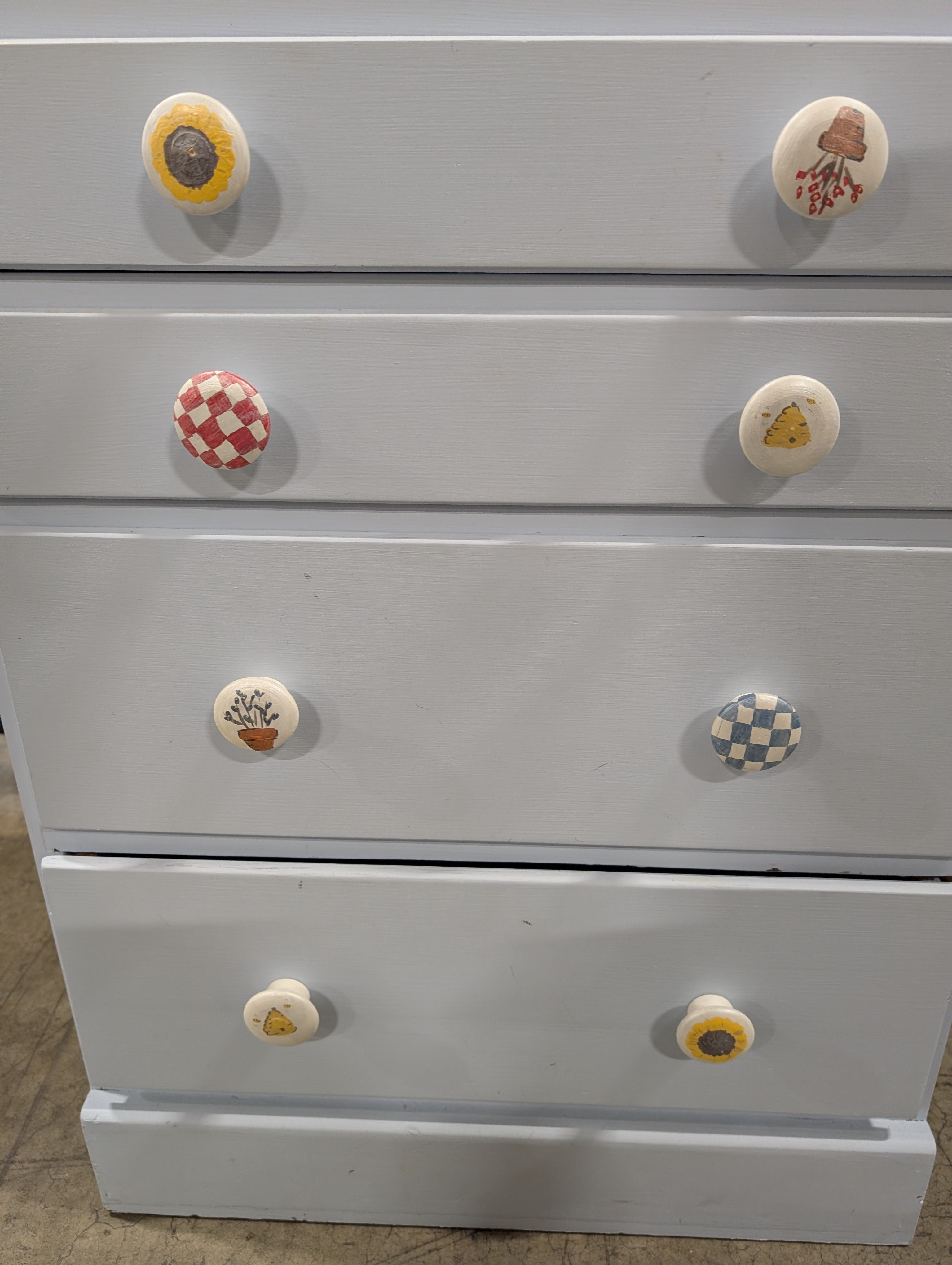 Pale Blue Wooden Four-Drawer Chest with Decorative Knobs