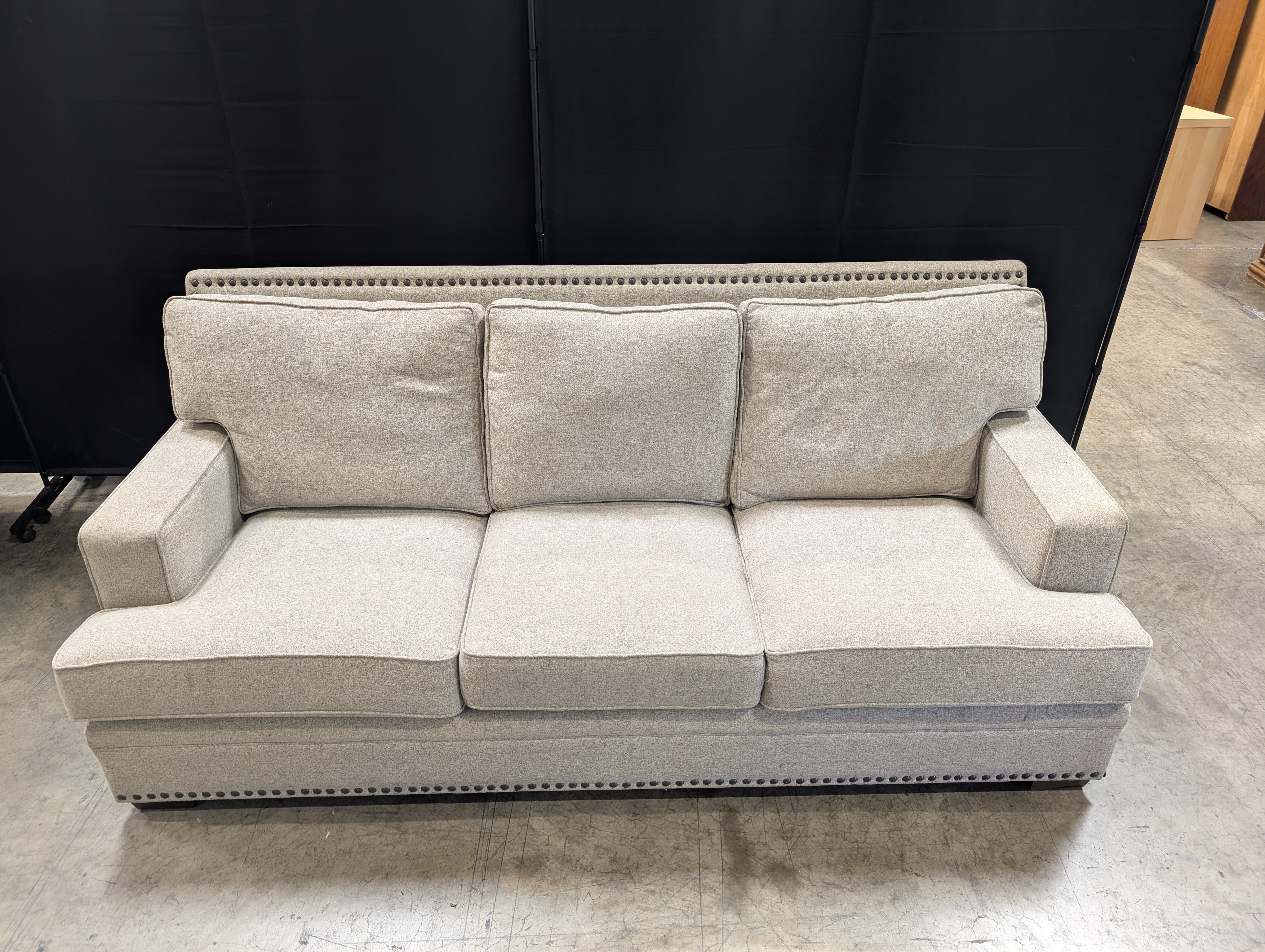 Grey Fabric Three-Seat Couch with Nailhead Trim