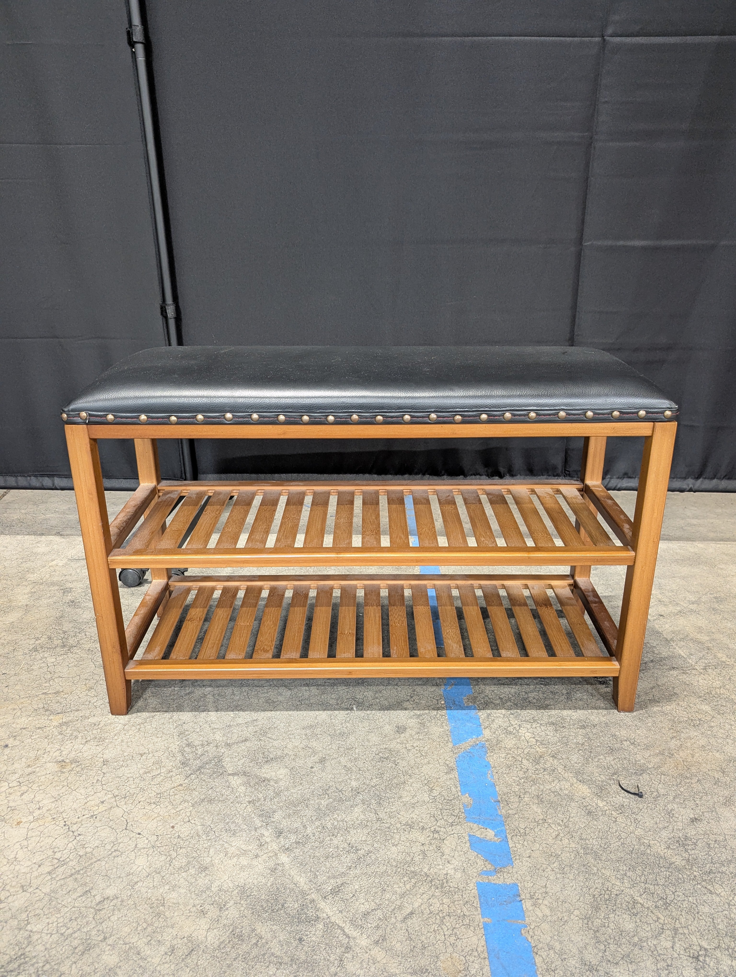 Hardwood Entryway Bench with Padded Black Upholstery and Slatted Shelves