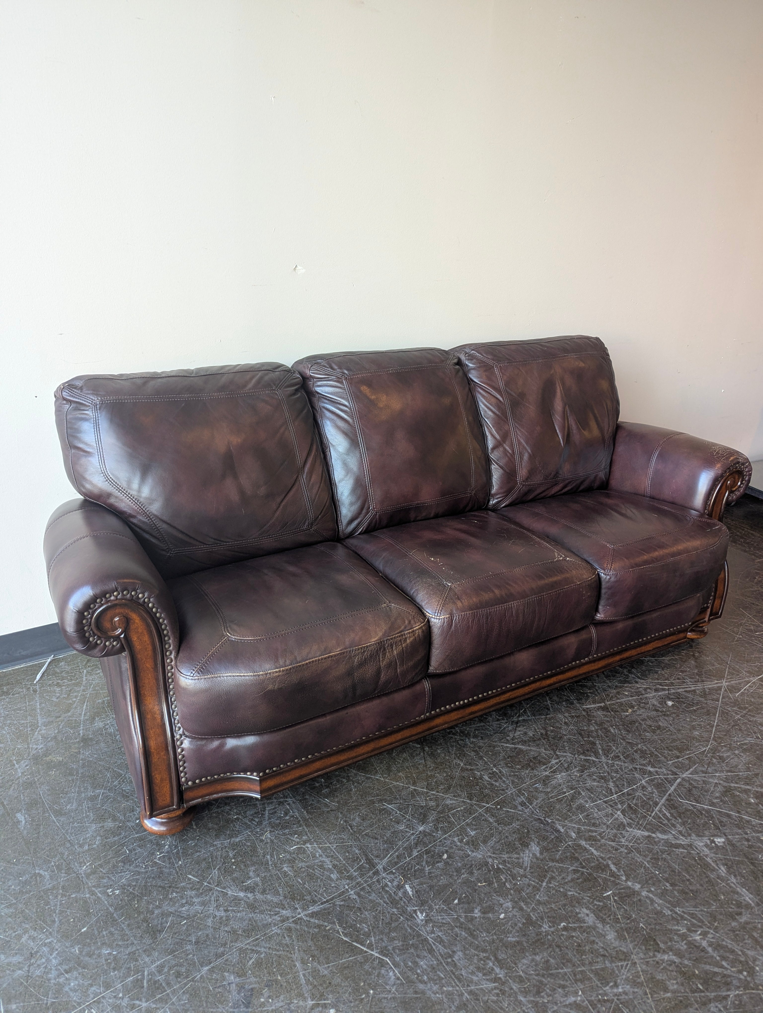 Classic Burgundy Leather Three-Seater Sofa with Rolled Arms