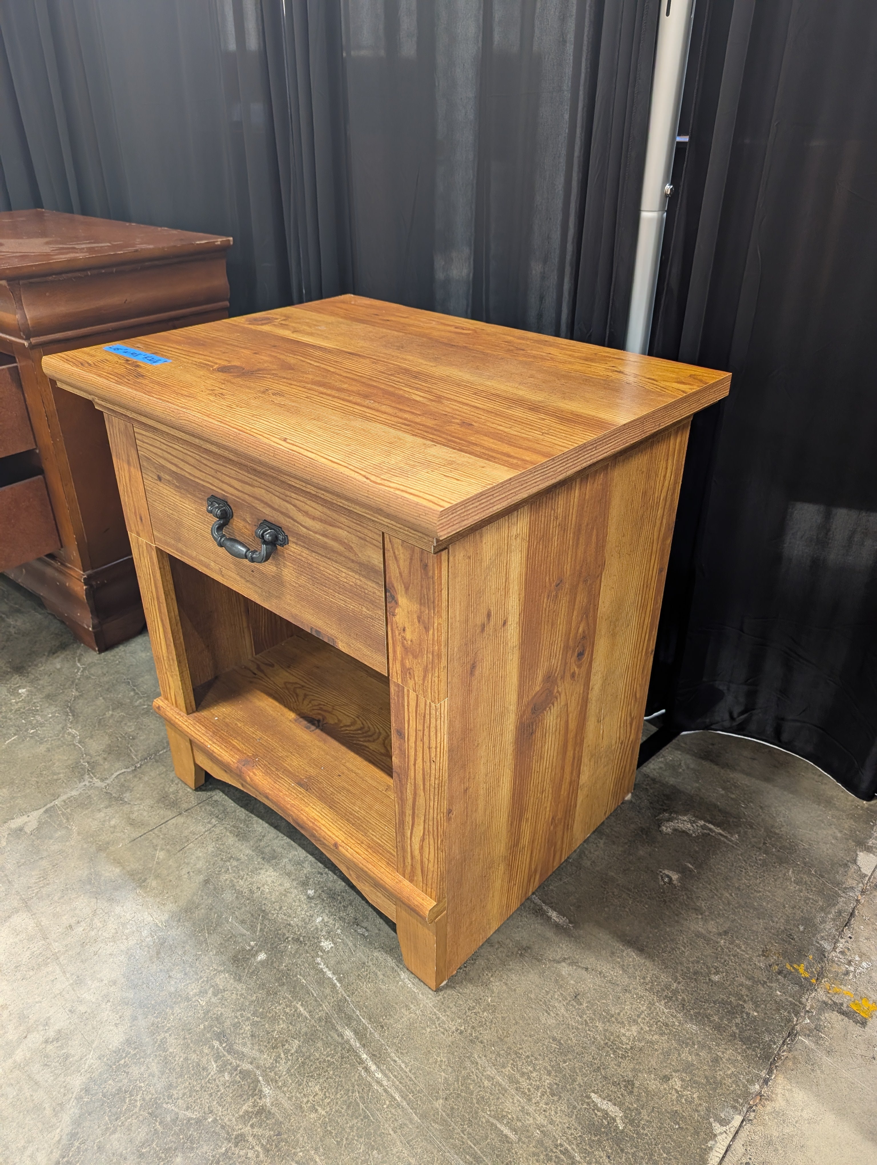 Brown Stained Wood Nightstand with Ornate Drawer Pull