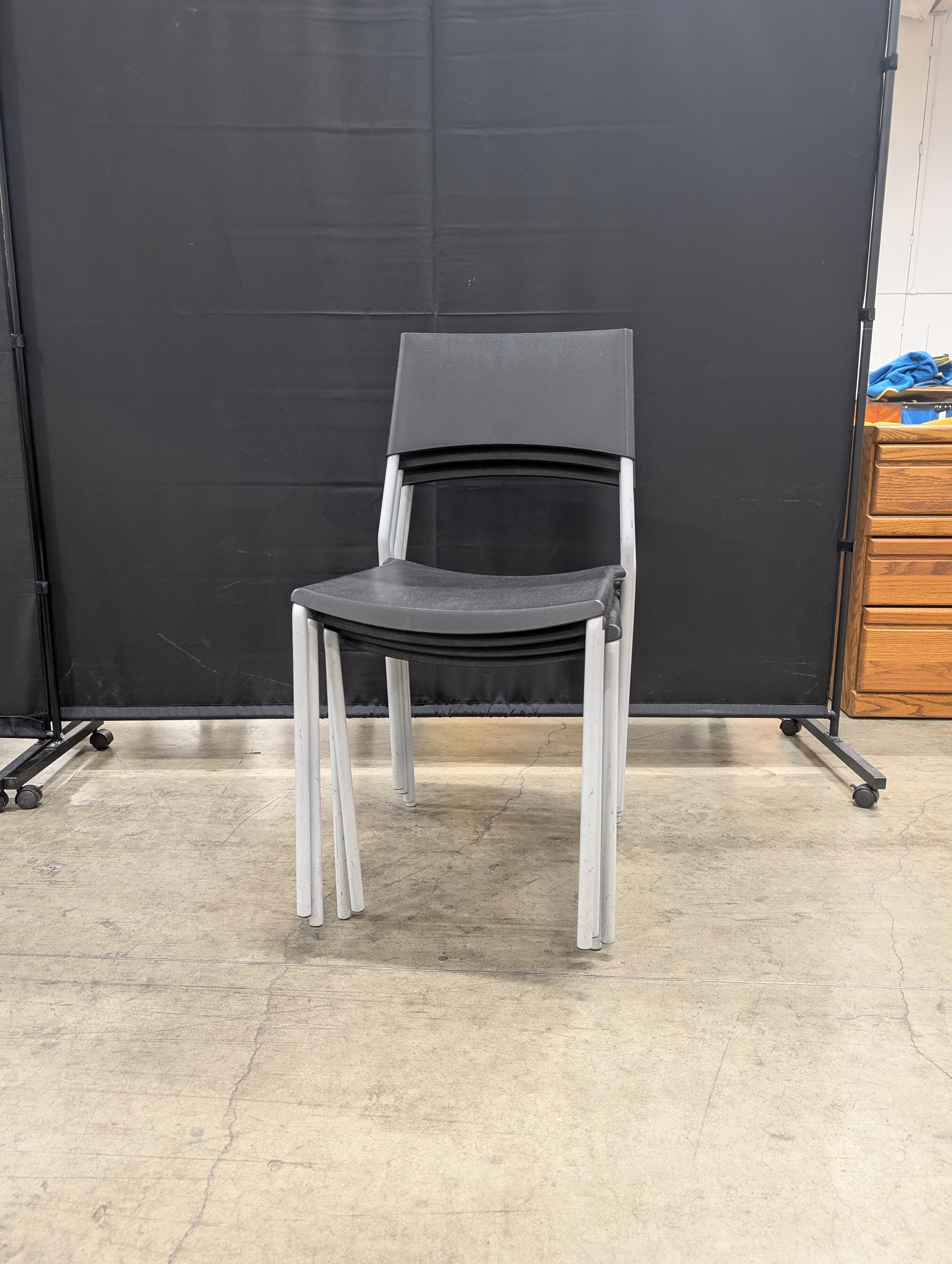 Set of Four Modern Black Stacking Chairs with Metal Frames