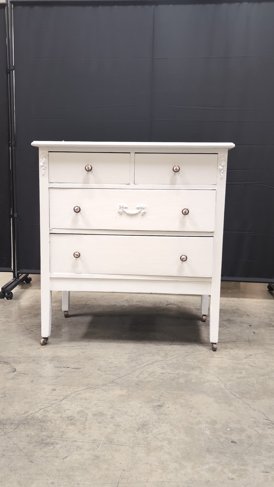Charming White Four-Drawer Chest with Decorative Knobs