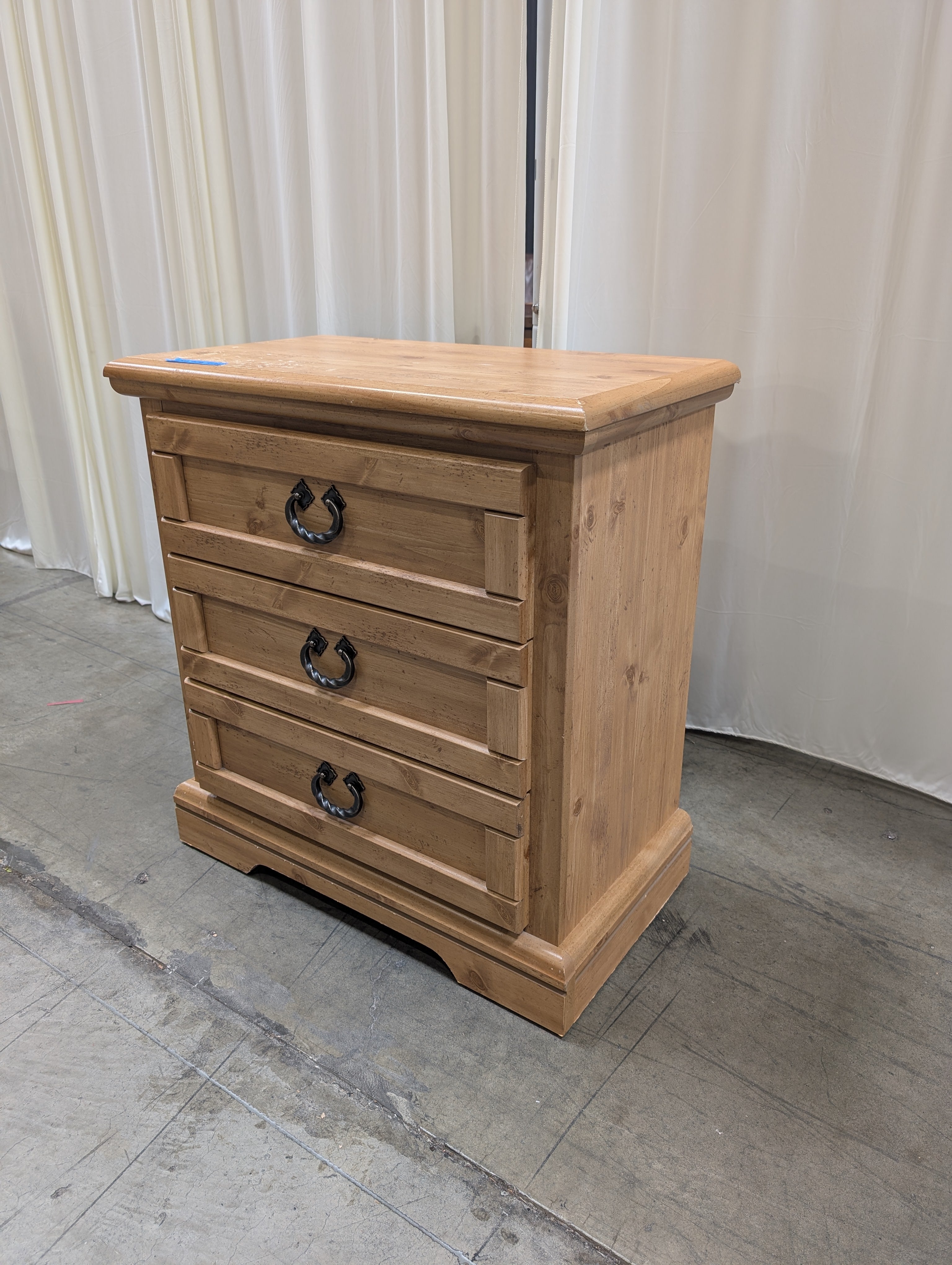Light Wood Three-Drawer Nightstand with Metal Pulls