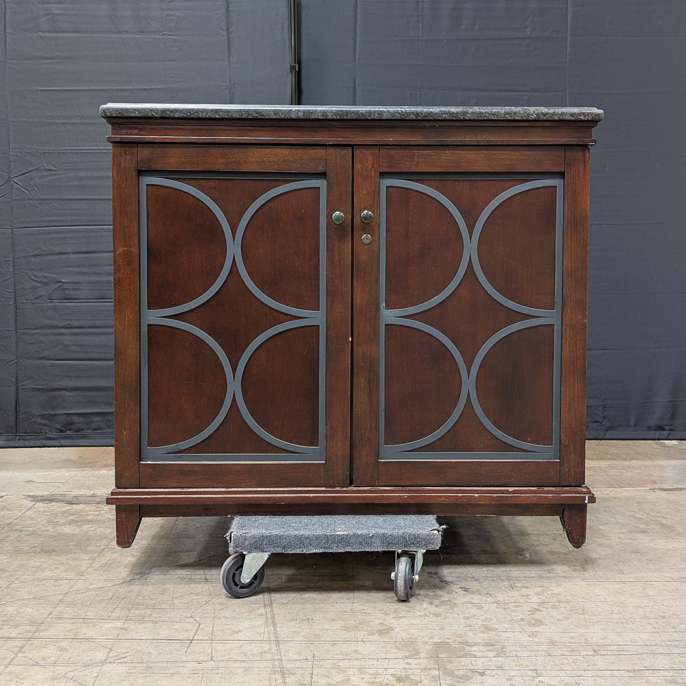 Dark Wood Storage Cabinet with Granite Top and Decorative Doors