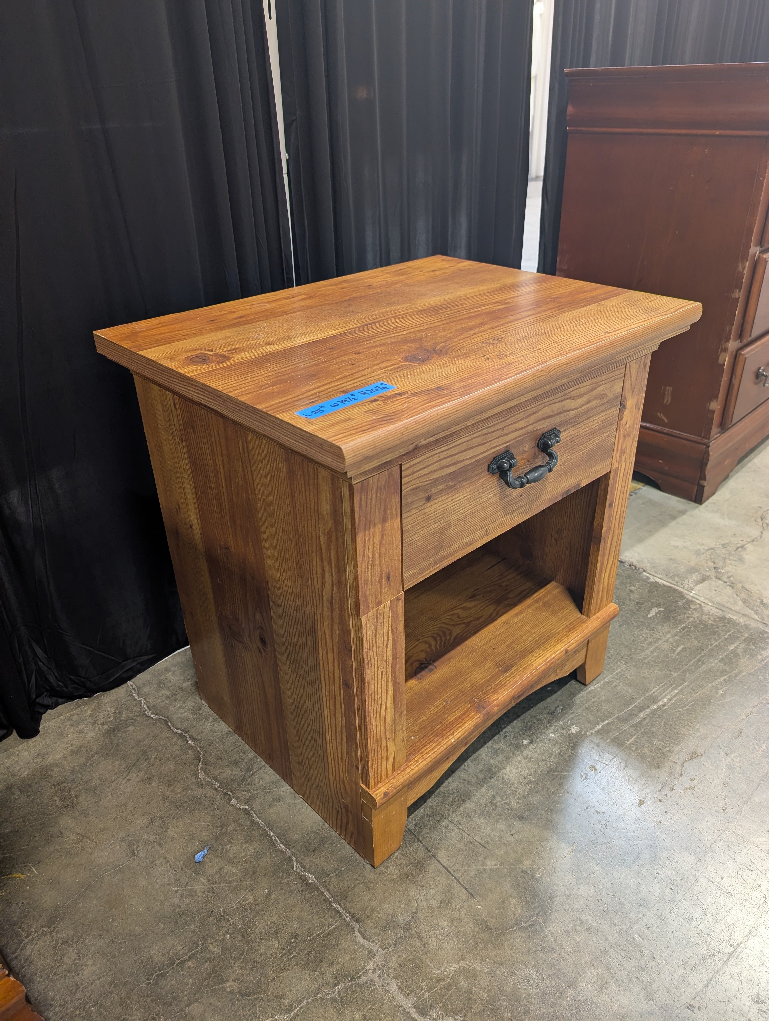 Brown Stained Wood Nightstand with Ornate Drawer Pull