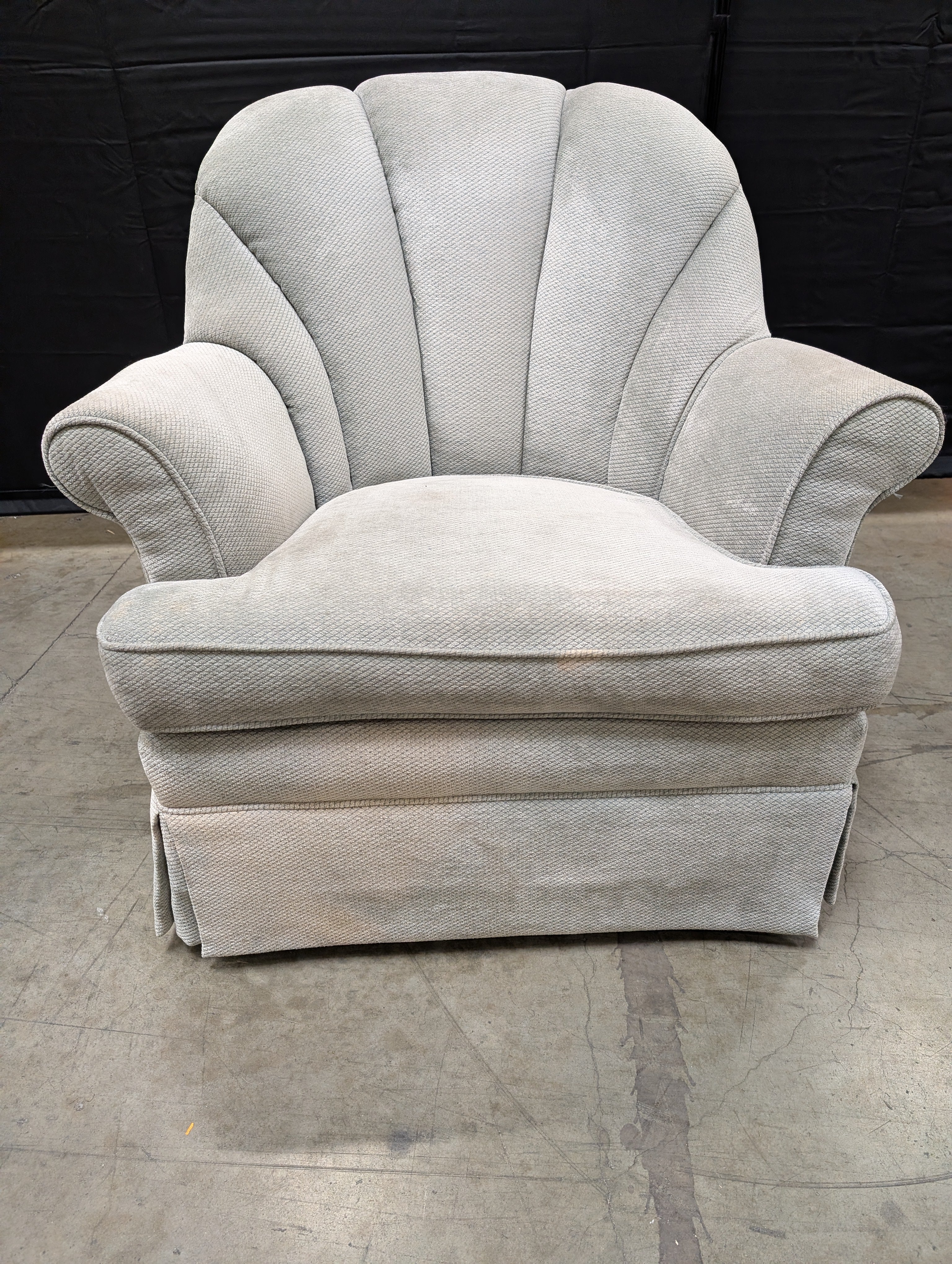 Textured Upholstered Scalloped Back Swivel Armchair