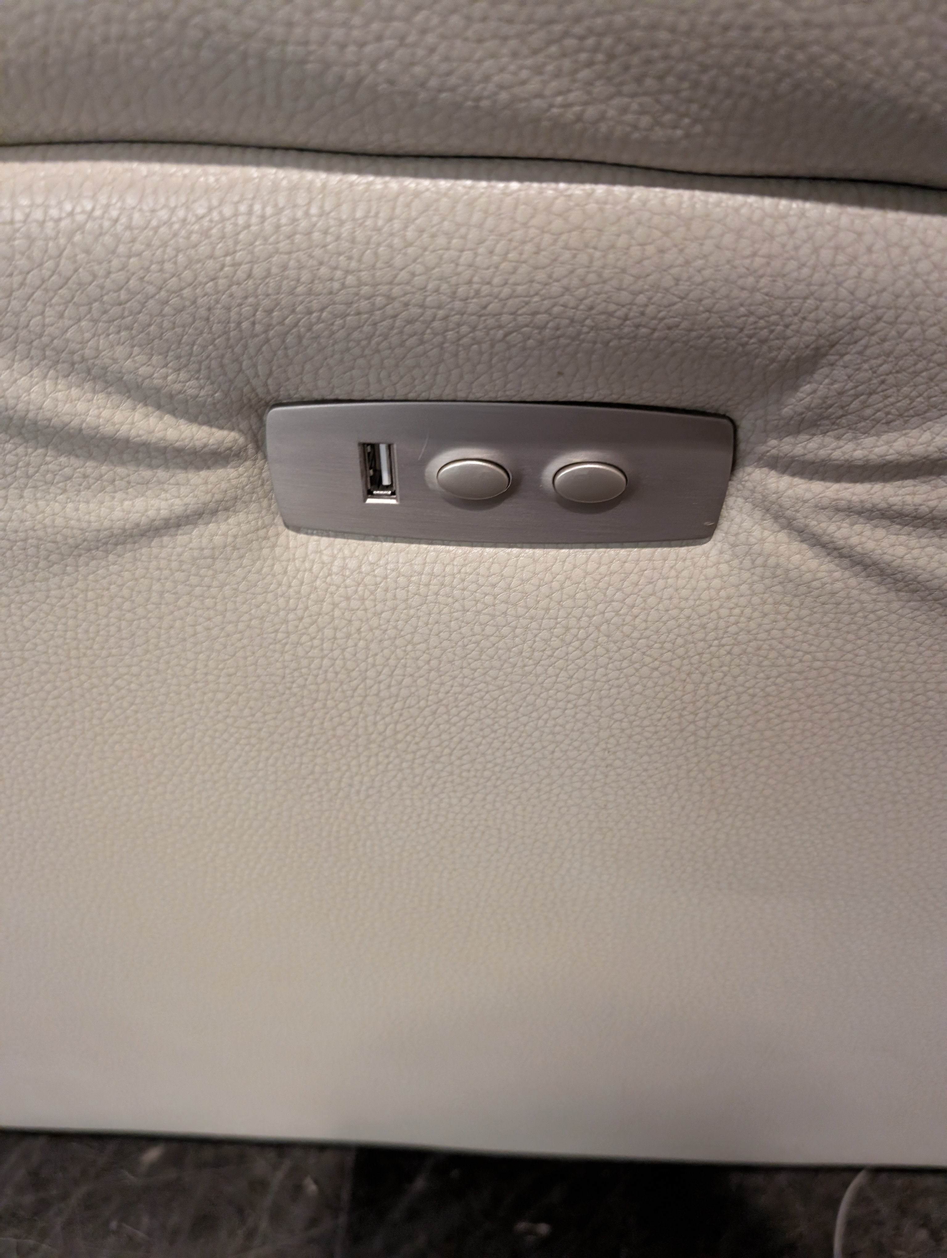 Cream Upholstered Two-Seater Reclining Sofa