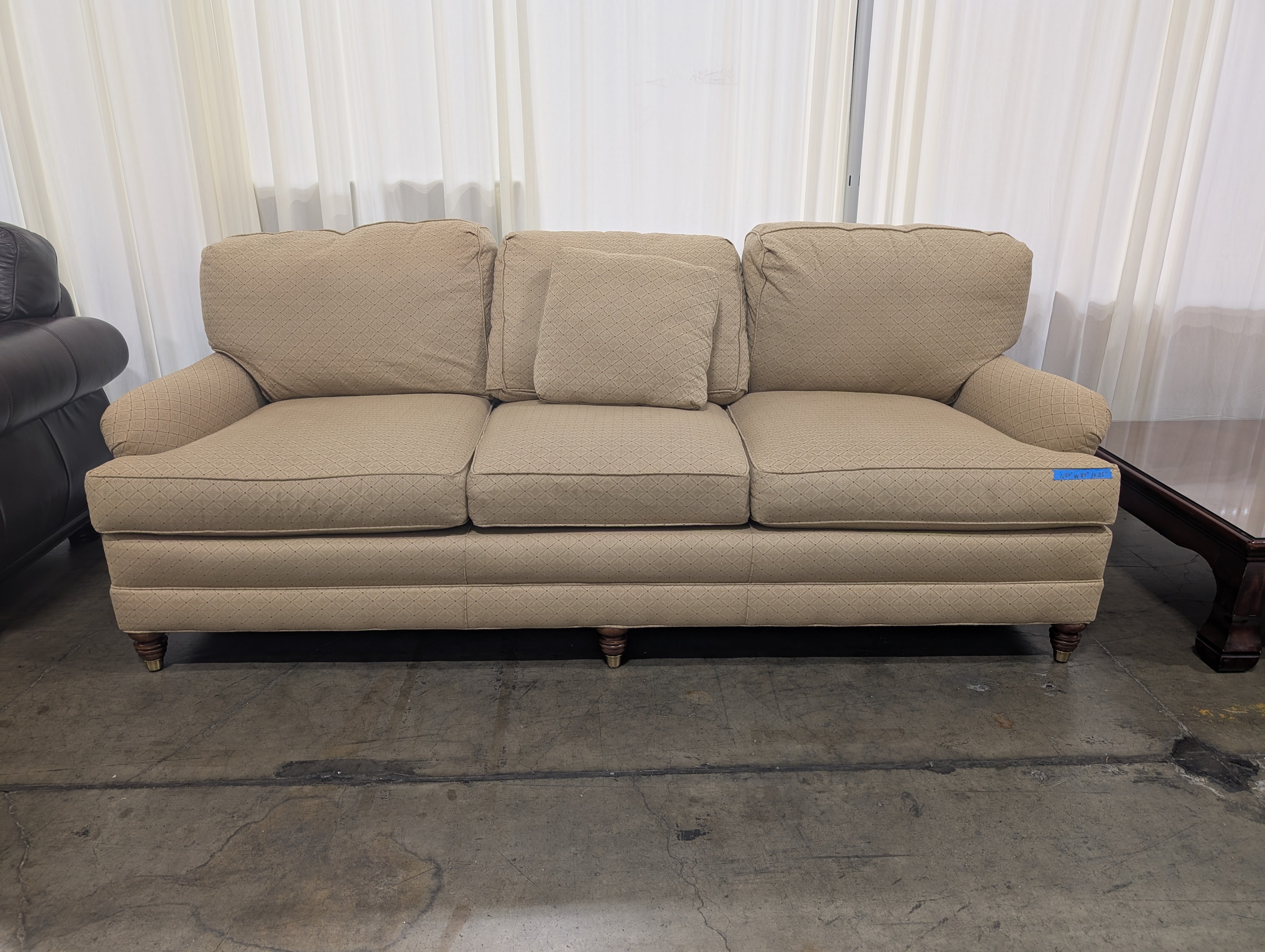 Tan Upholstered Three-Cushion Couch with Rolled Arms