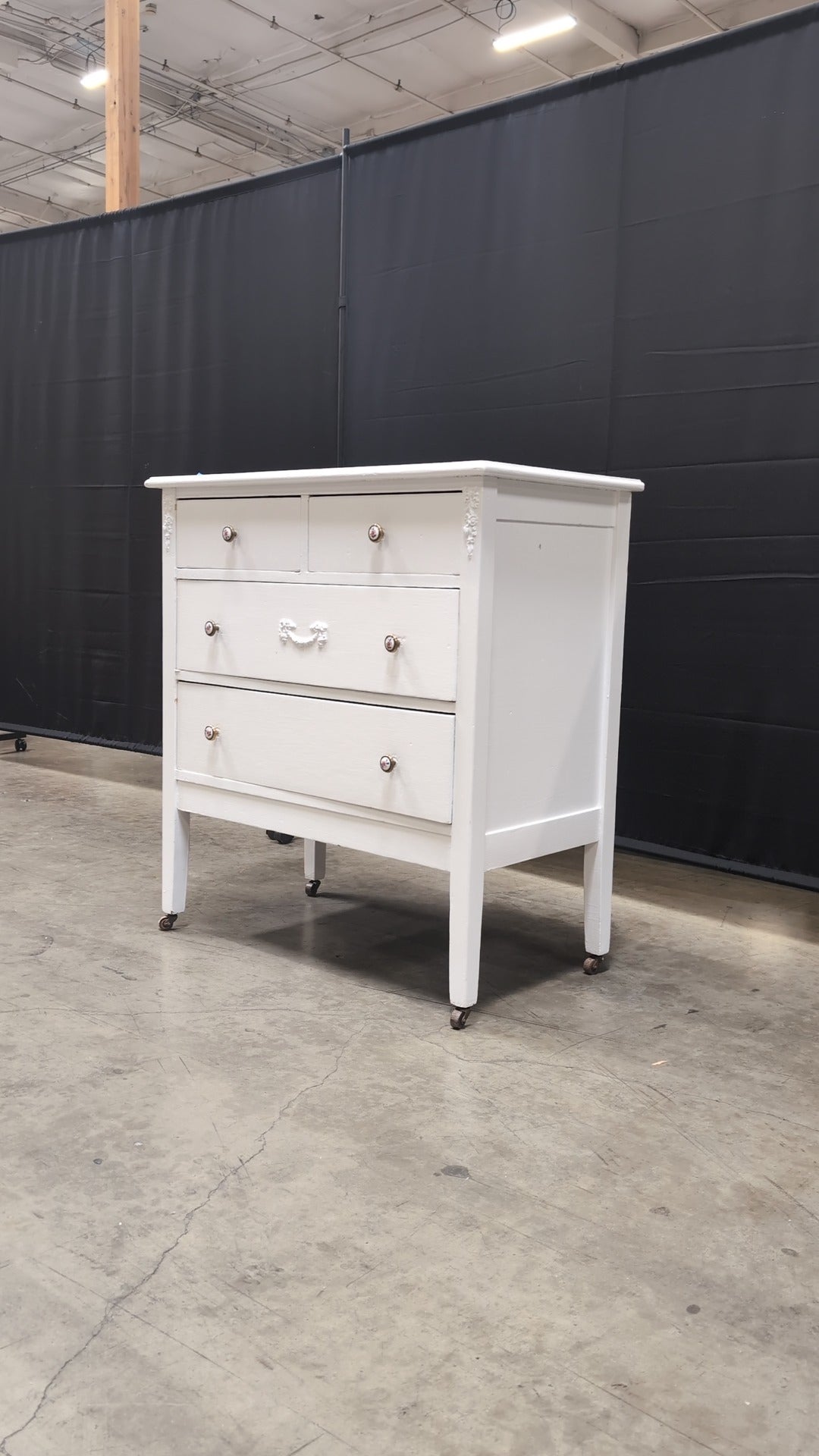 Charming White Four-Drawer Chest with Decorative Knobs