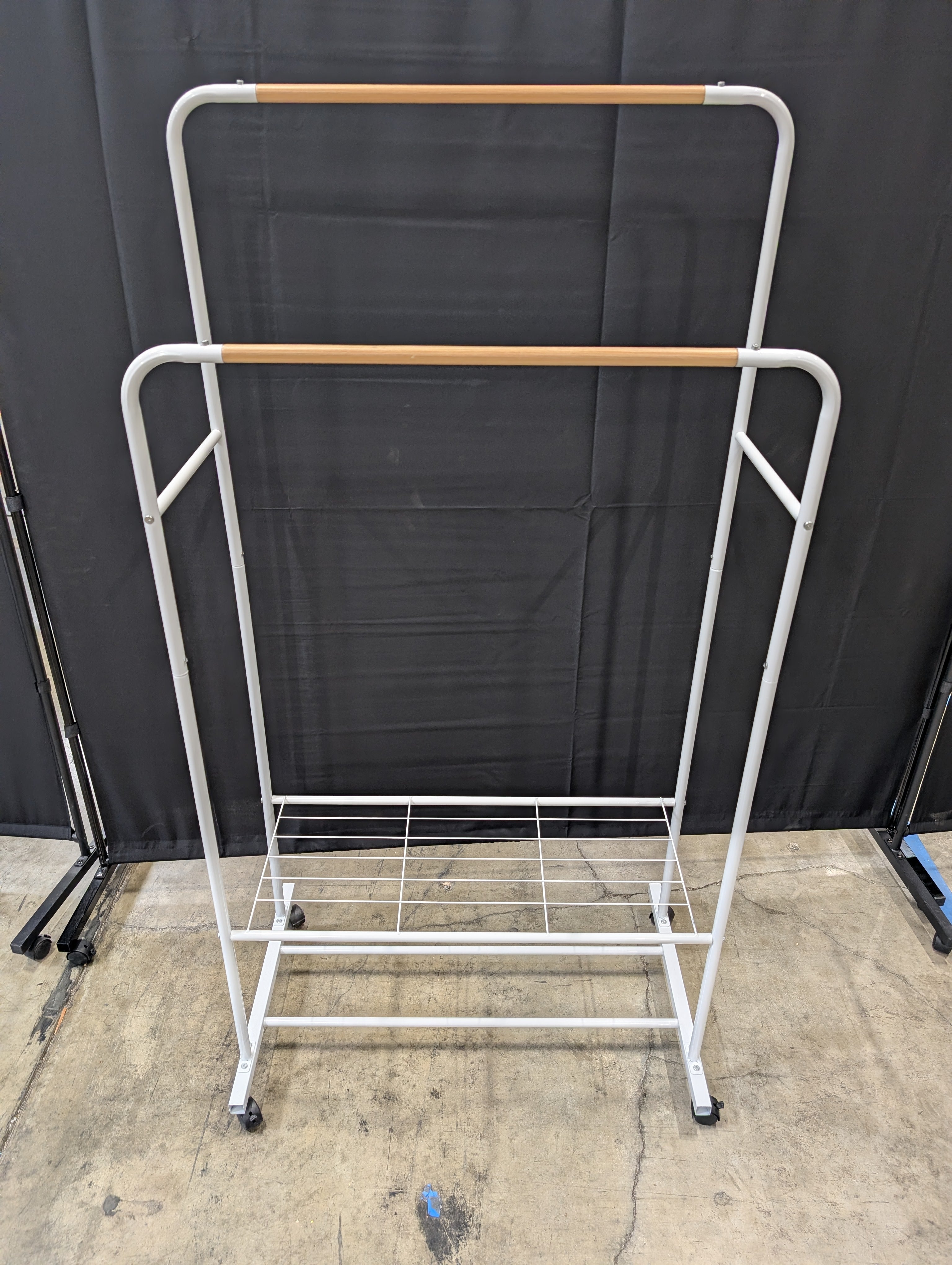 White Metal Rolling Garment Rack with Dual Hanging Rails and Storage Shelf