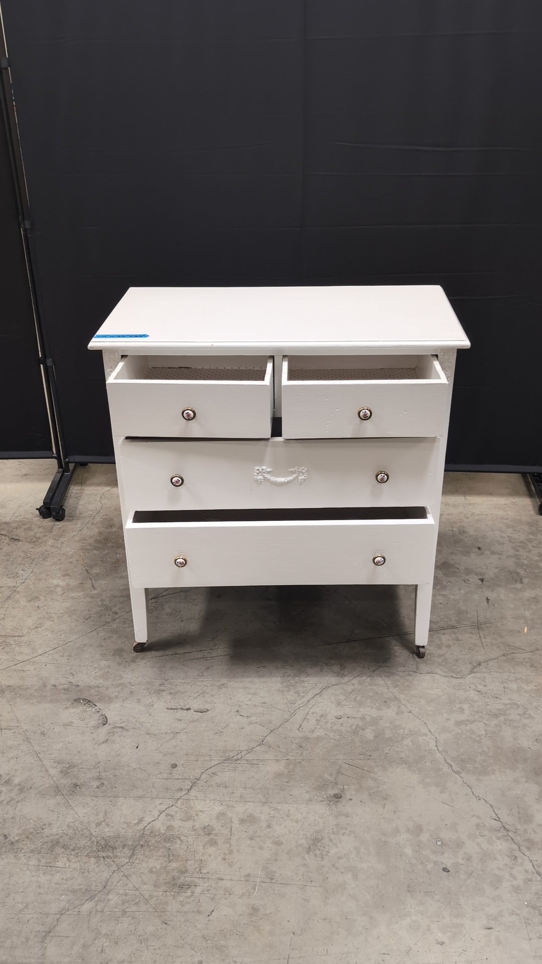 Charming White Four-Drawer Chest with Decorative Knobs