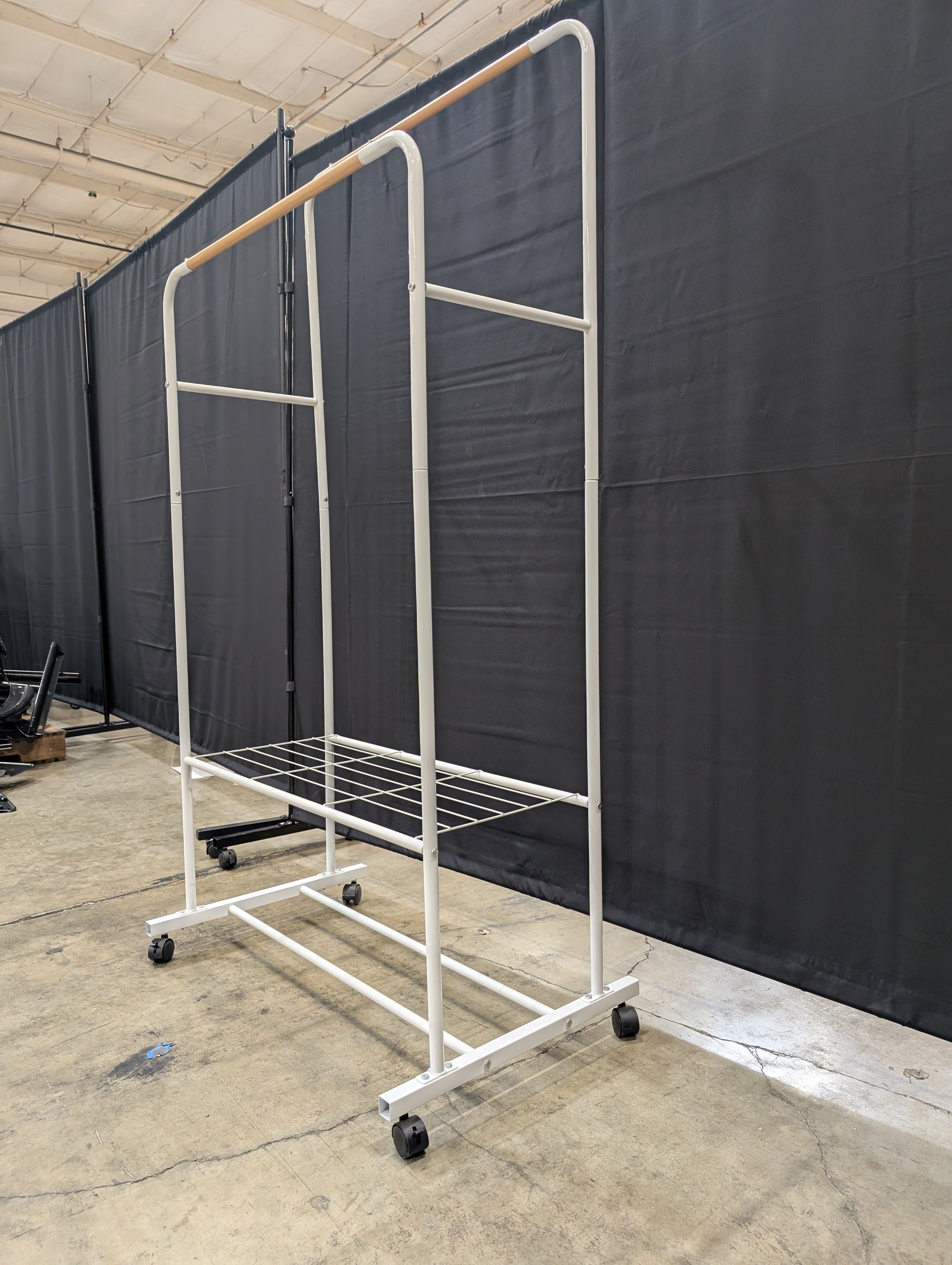 White Metal Rolling Garment Rack with Dual Hanging Rails and Storage Shelf