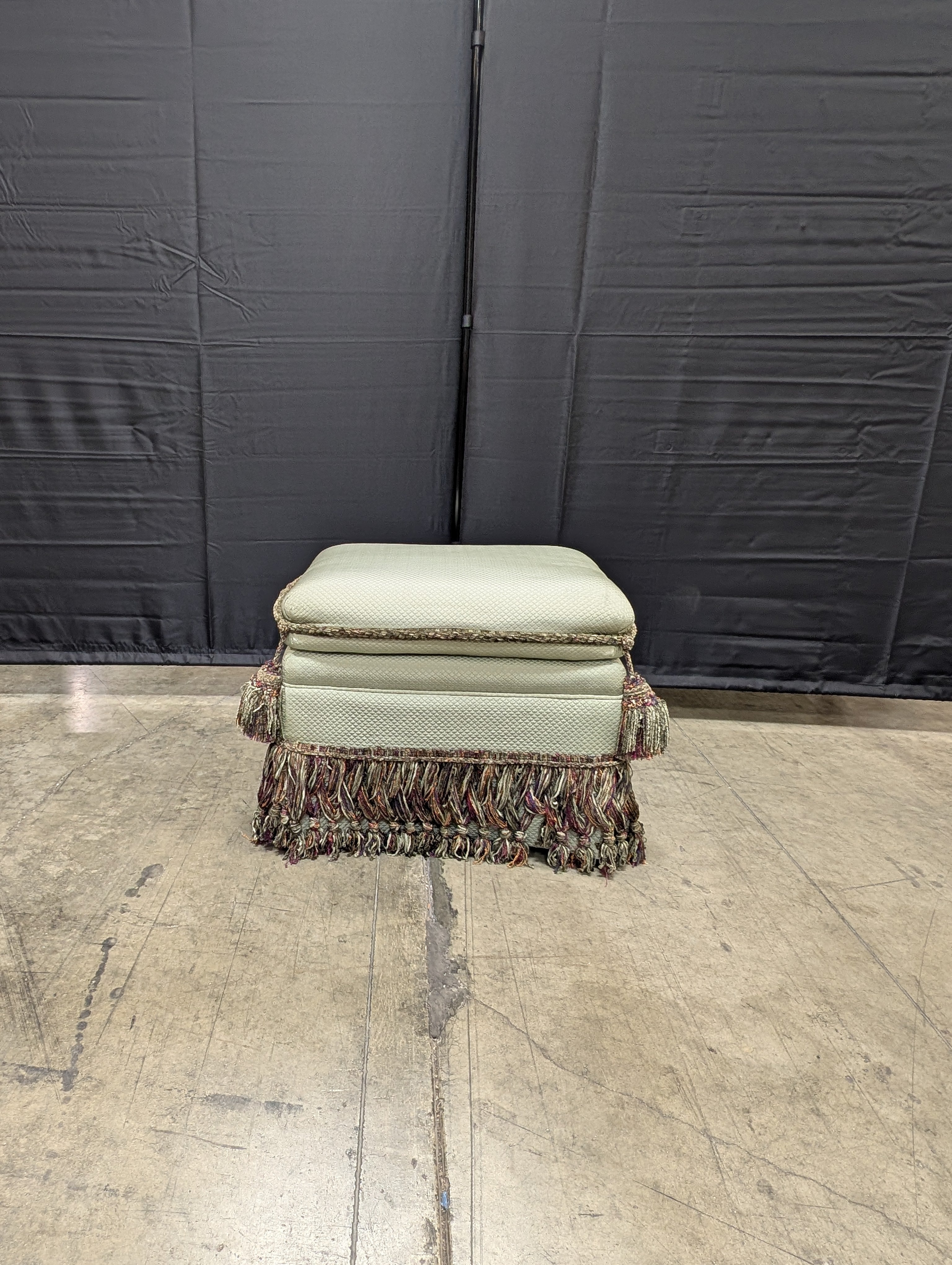 Textured Upholstered Cushion with Tassel Fringe Trim
