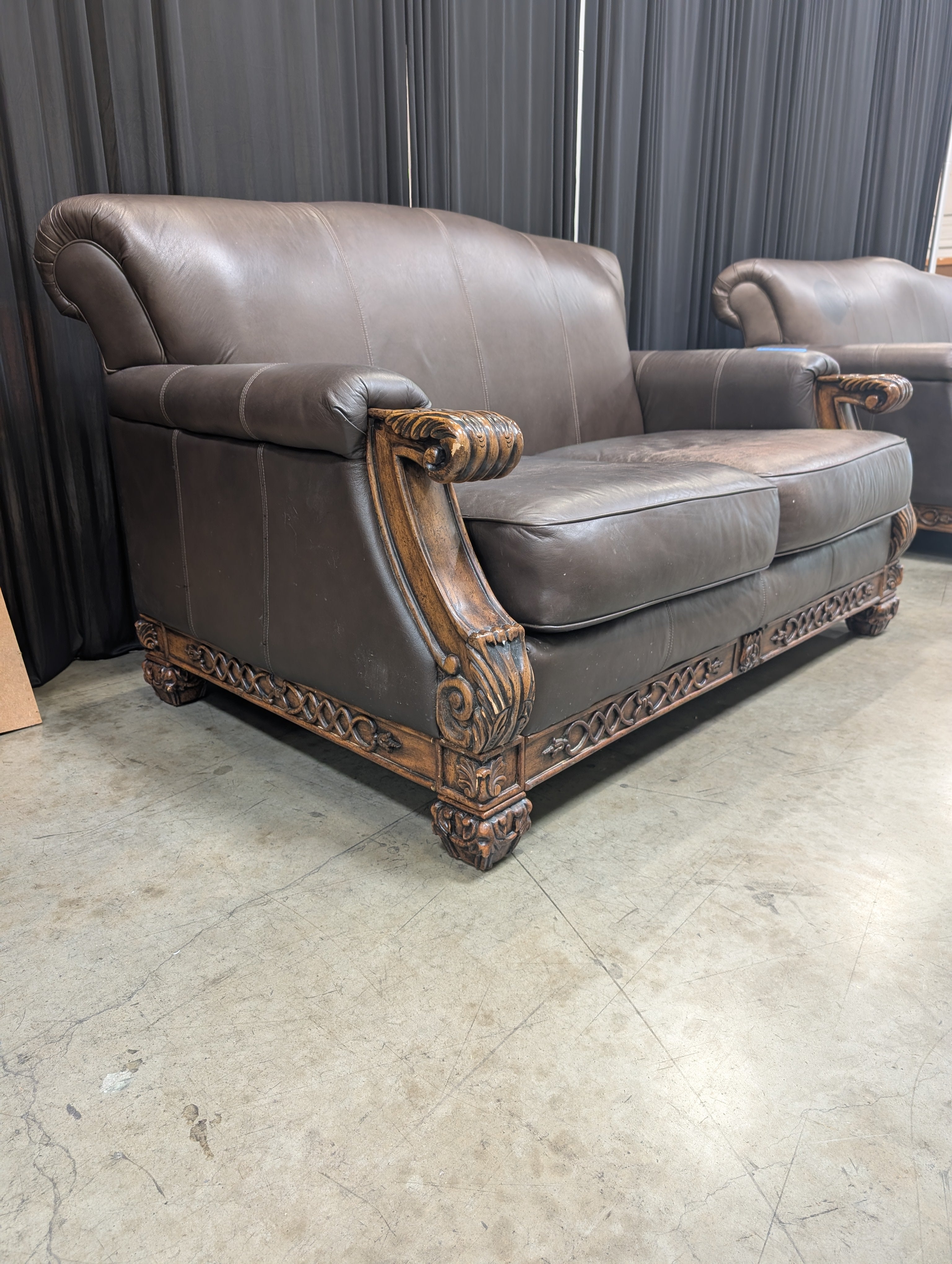 Traditional Brown Leather Loveseat with Carved Wood