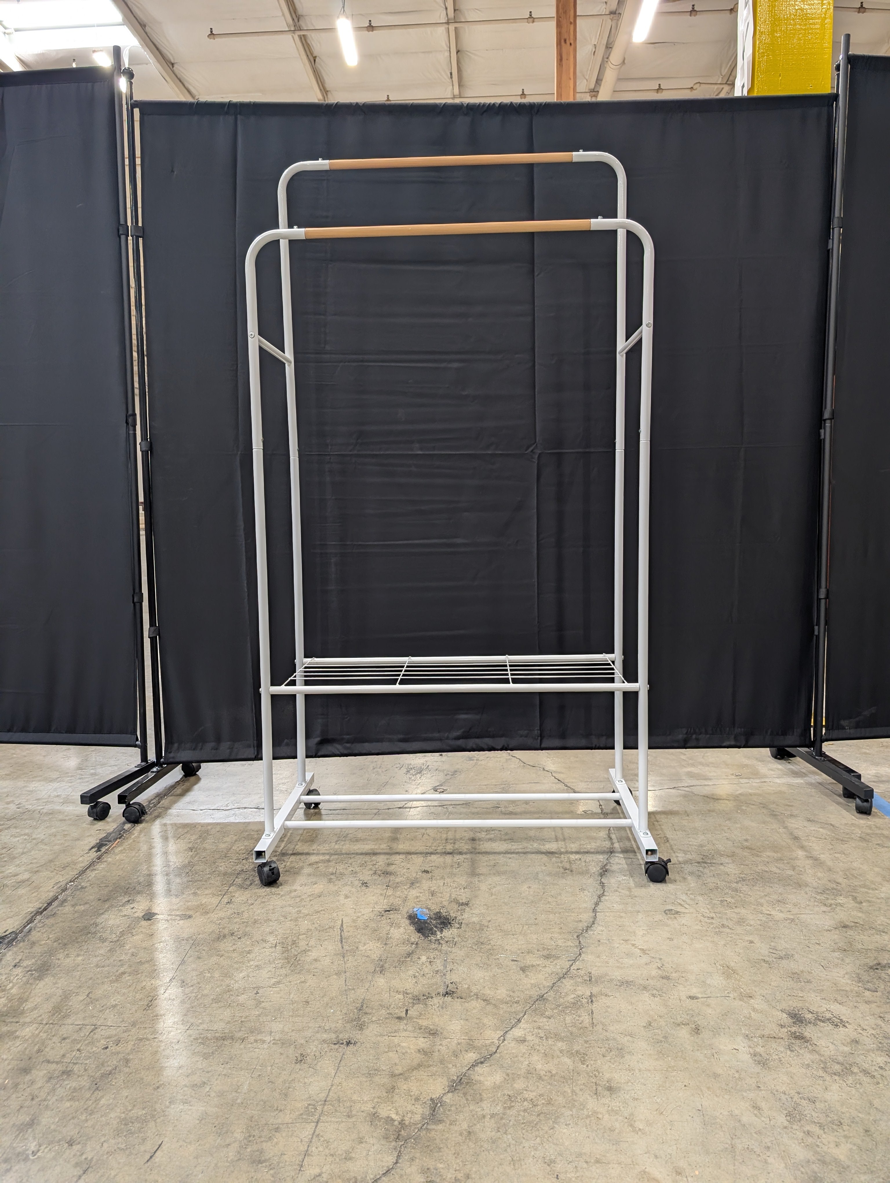 White Metal Rolling Garment Rack with Dual Hanging Rails and Storage Shelf