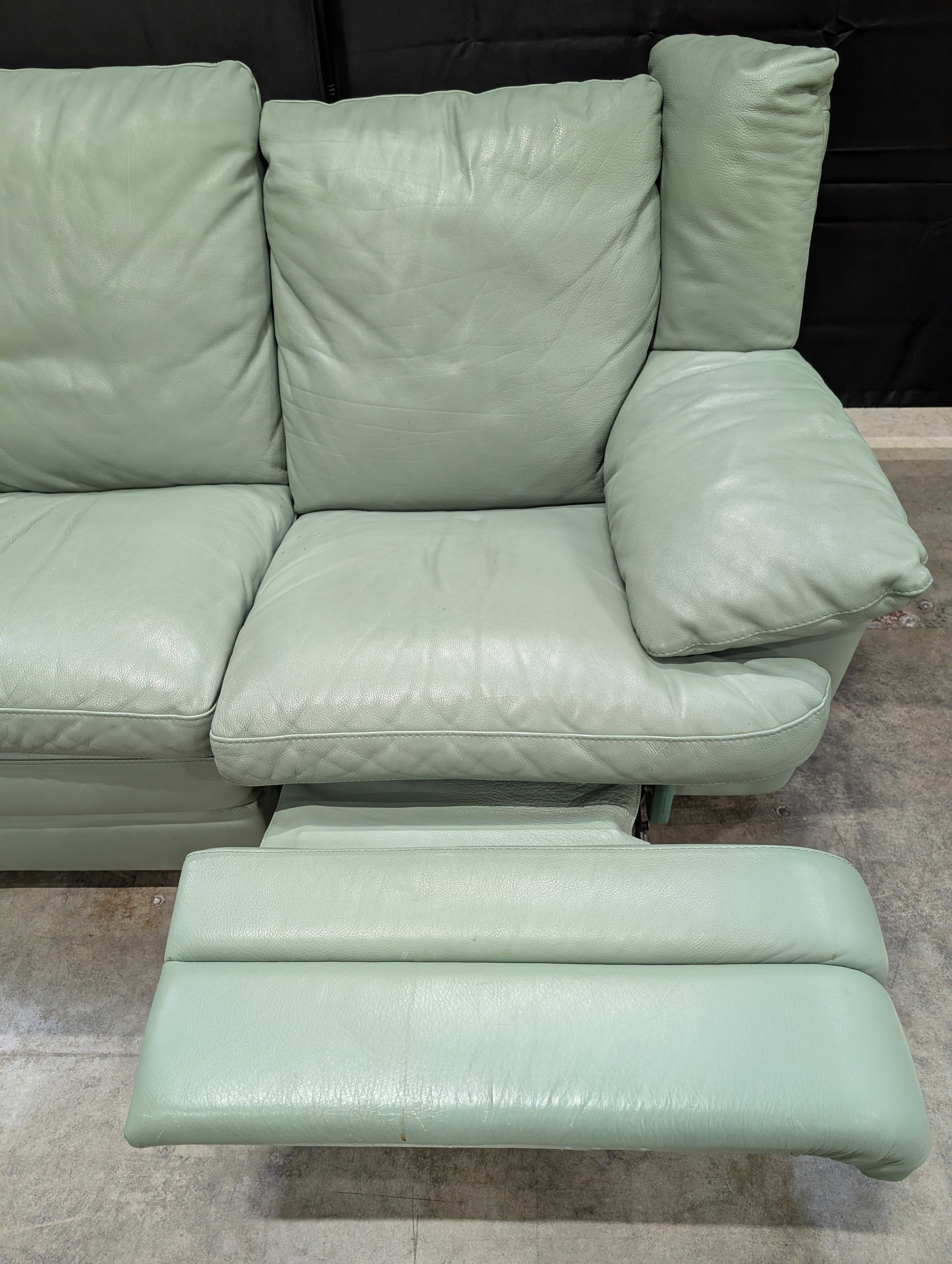 Charming Mint Green Leather Two-Seater Sofa with Plush Padded Arms