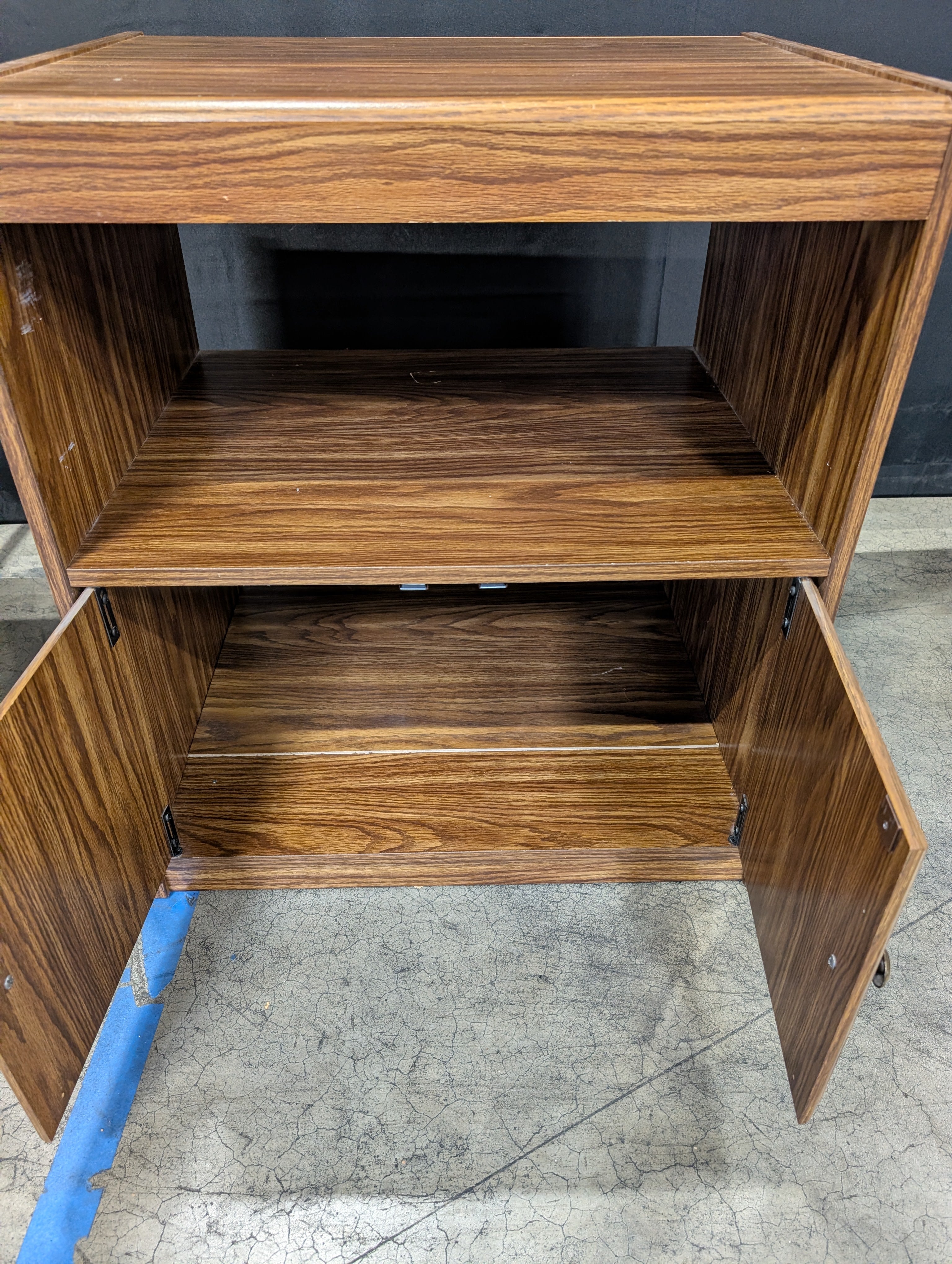 Rolling Brown Wood-Look Accent Cabinet with Carved Doors