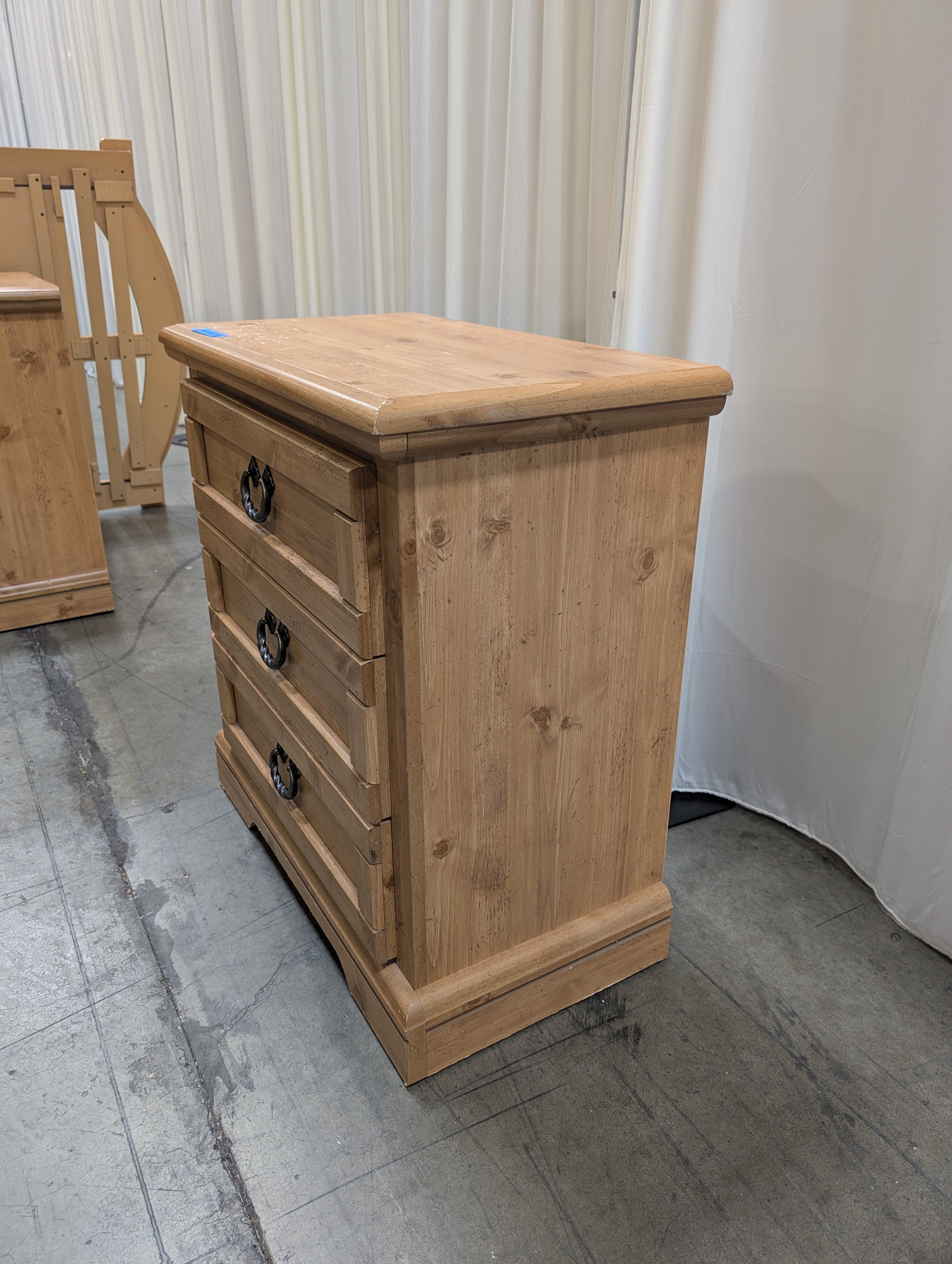 Light Wood Three-Drawer Nightstand with Metal Pulls